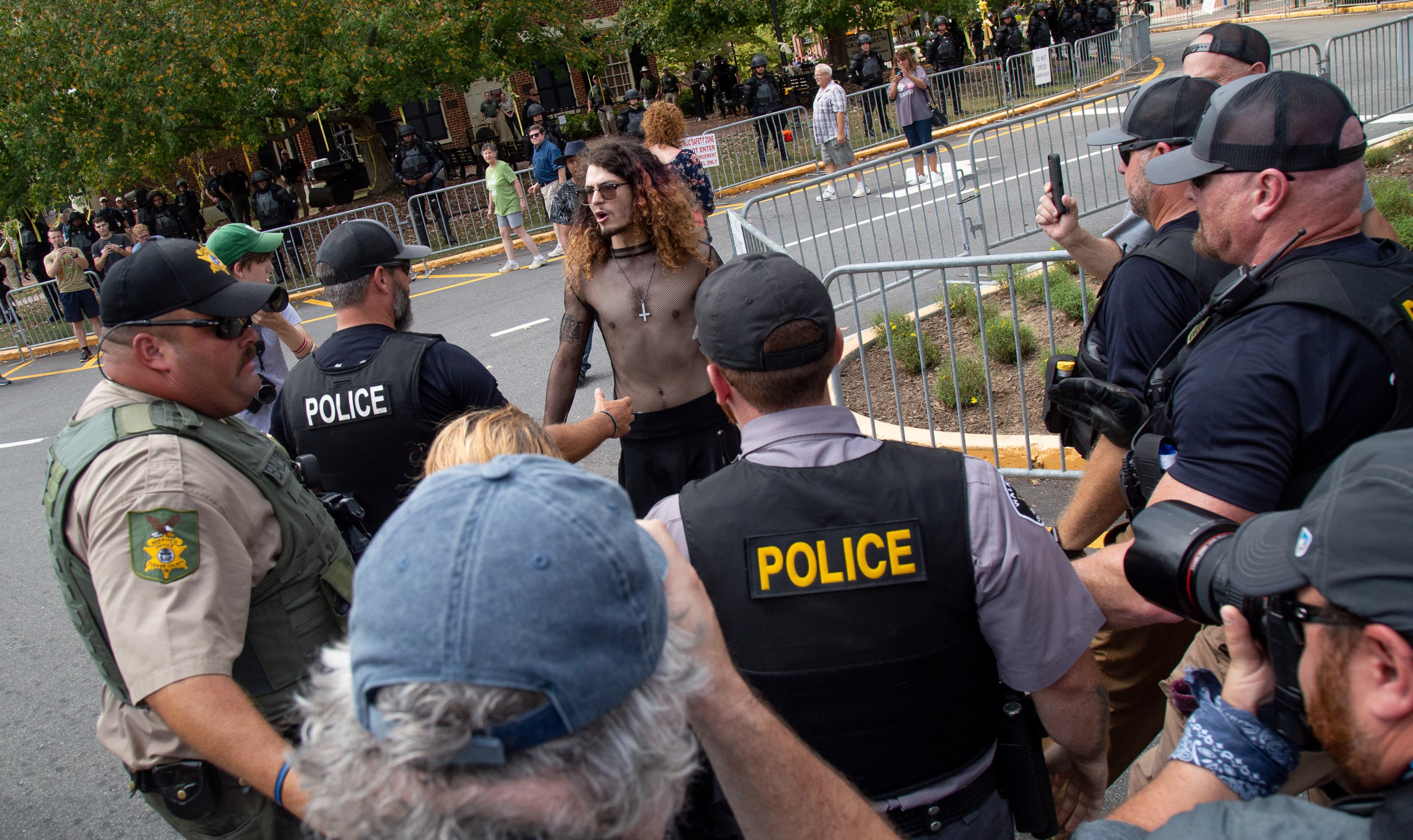A counterprotester who entered a pro-Trump rally is quickly surrounded by police officers in Dahlonega on Saturday, September 14, 2019. STEVE SCHAEFER / SPECIAL TO THE AJC