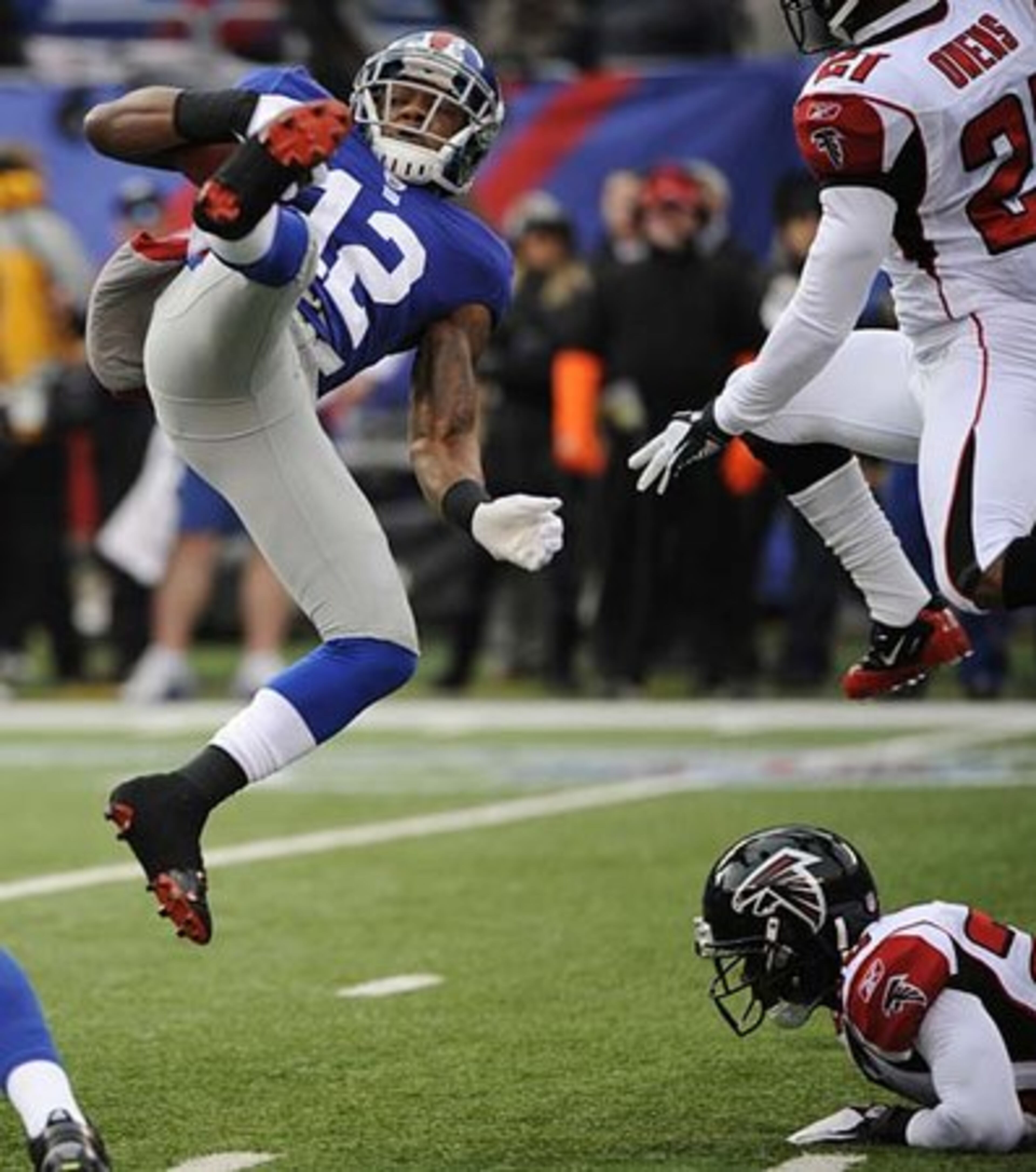 Giants wide receiver Jerrel Jernigan (12) flips in the air after getting hit.