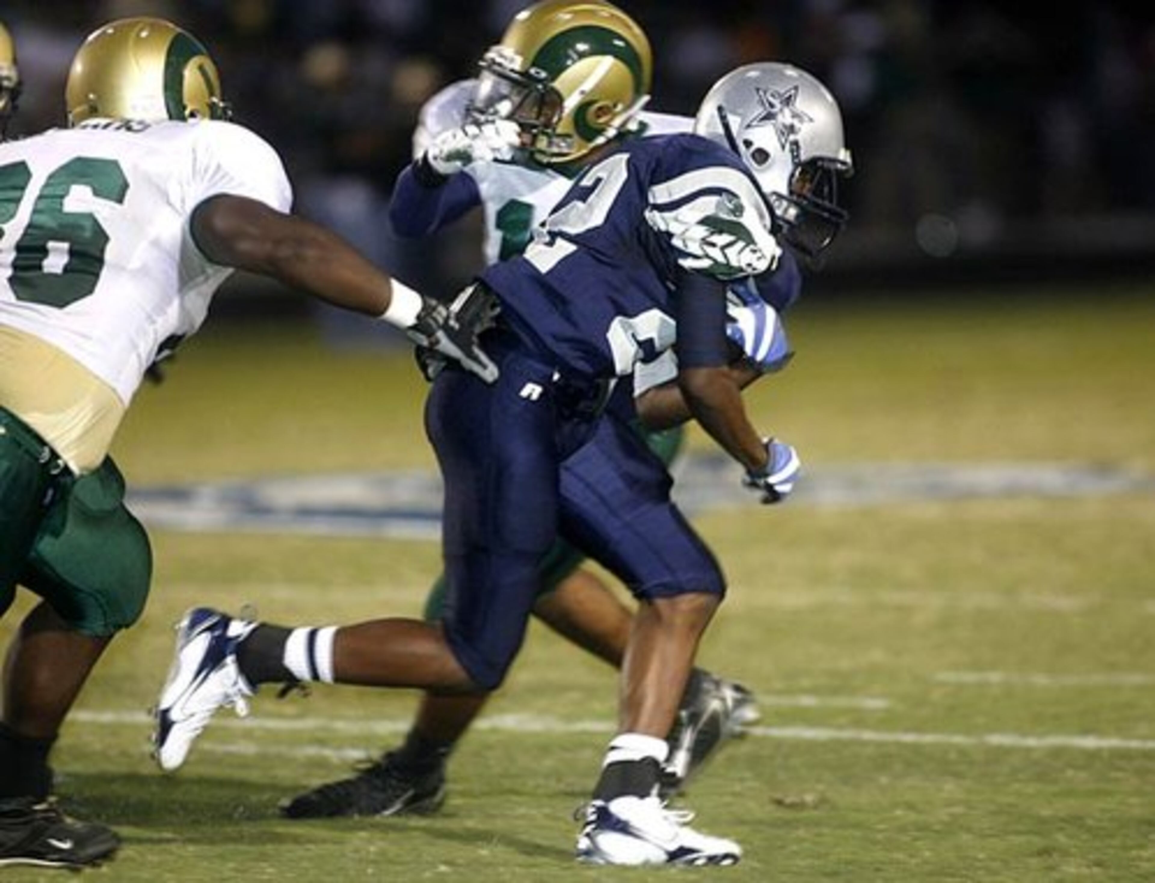 South Gwinnett's Aaron Wimberly (22) dashes past a pair of Grayson defenders.