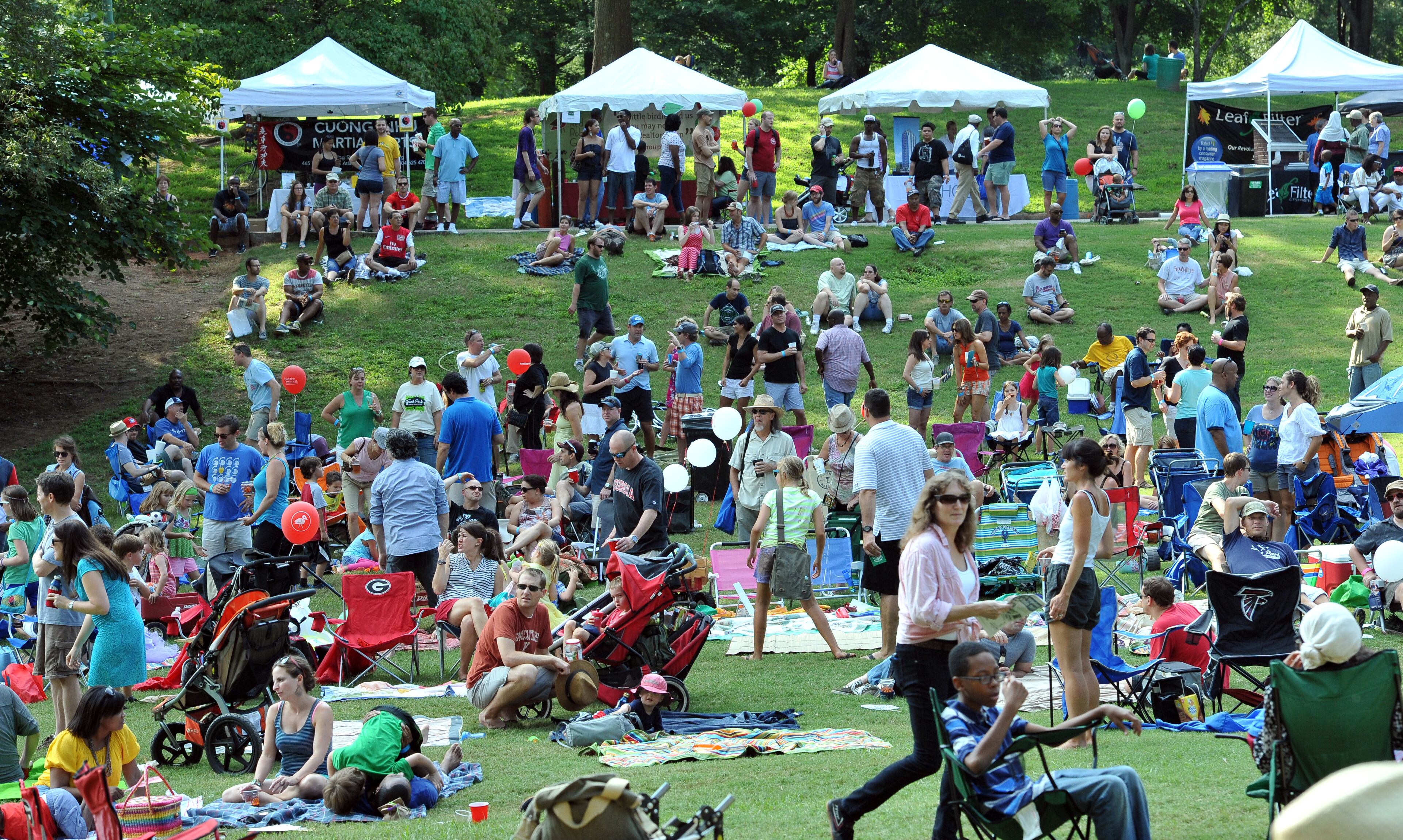 Hundreds of festival goers enjoy the beautiful weather and entertainment during Grant Park Summer Shade Festival on Saturday, August 24, 2013. The Grant Park Summer Shade Festival features an artist market, children's activities, great food, live music and the Adams Realtors 5K Run for the Park. The Children's Fun Center is a family favorite with storytellers, jugglers, sing-a-longs and kid-sized make-and-take projects. HYOSUB SHIN / HSHIN@AJC.COM