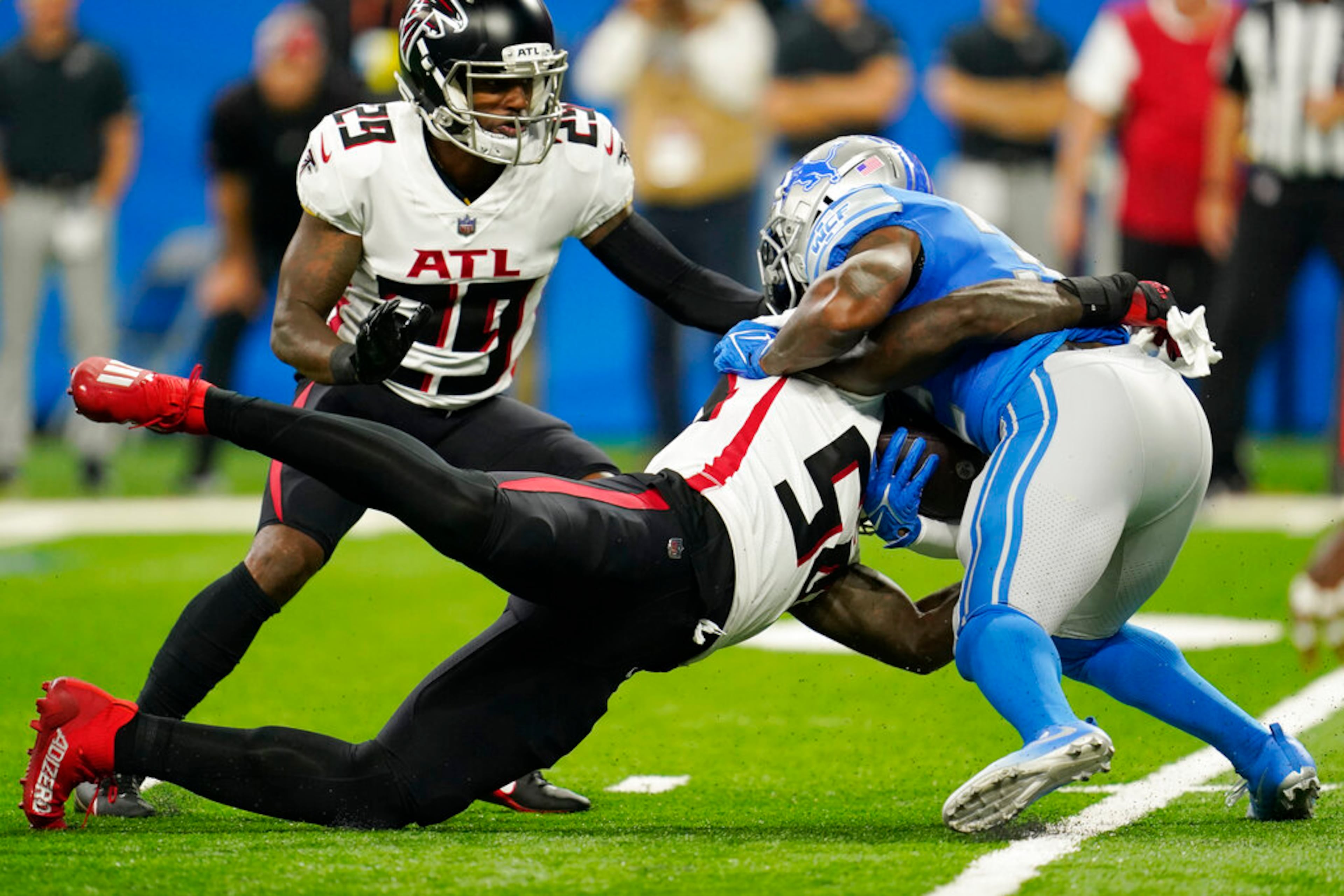 Atlanta Falcons linebacker Rashaan Evans (54) tackles Detroit Lions running back D'Andre Swift during the first half of a preseason NFL football game, Friday, Aug. 12, 2022, in Detroit. (AP Photo/Paul Sancya)