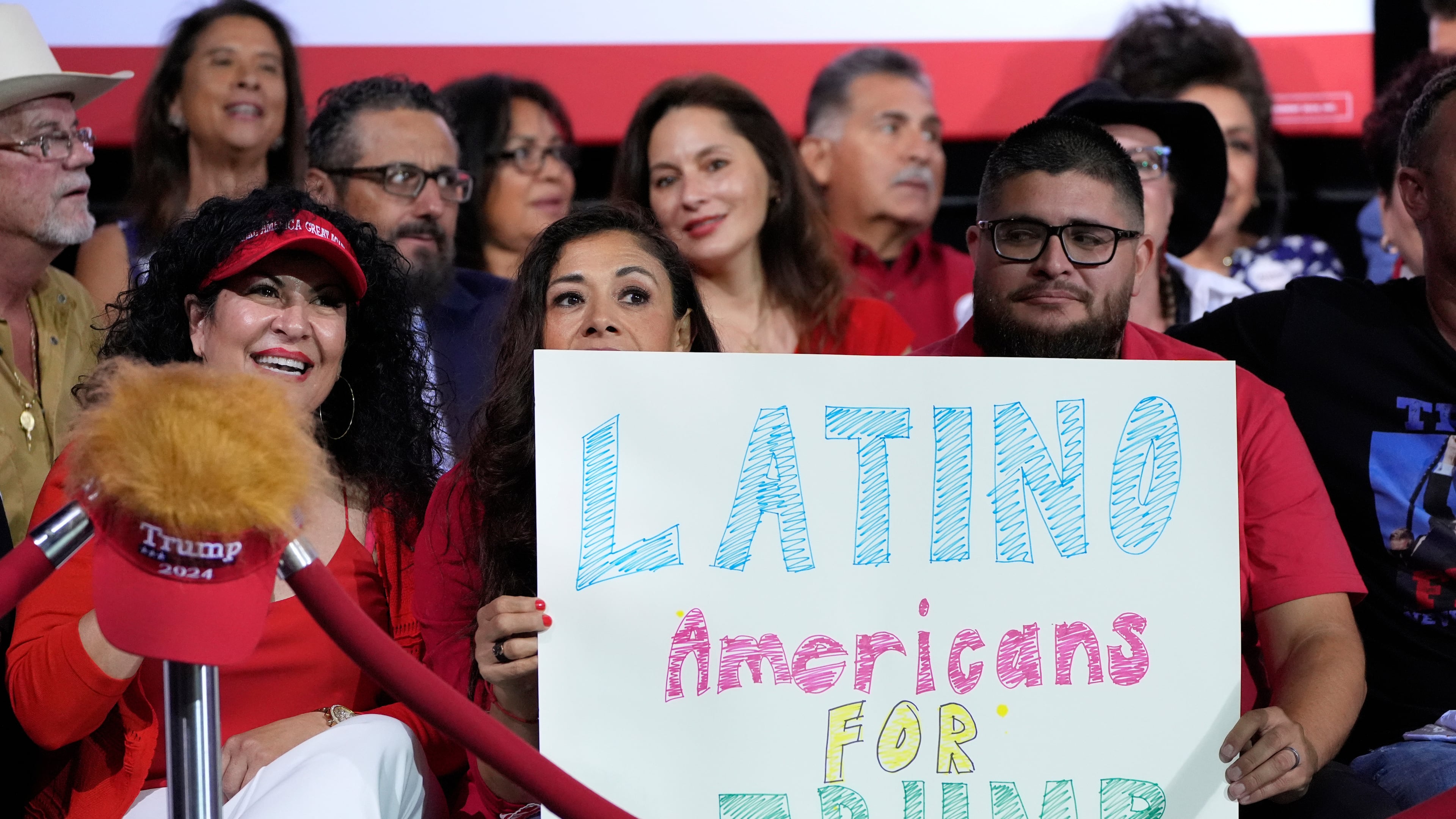 FILE - Supporters hold a sign before Republican presidential nominee former President Donald Trump arrives to speak during a campaign event, Sept.12, 2024, in Tucson, Ariz. (AP Photo/Alex Brandon, File)