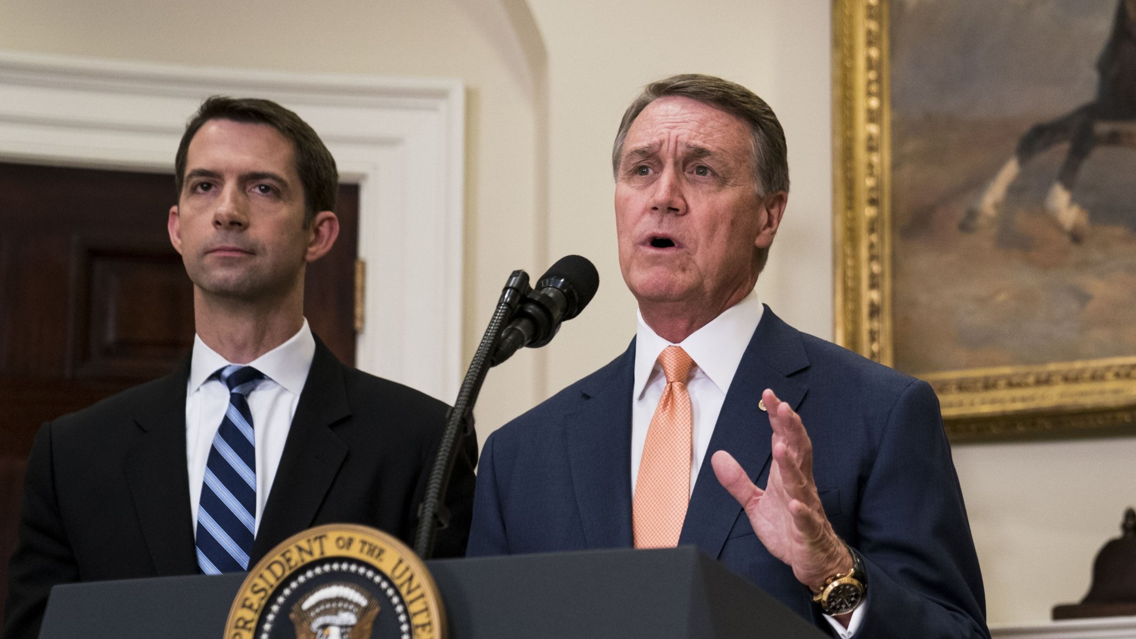 Sen. David Perdue, R-Ga., (foreground) and Sen. Tom Cotton, R-Ark., deliver a statement after President Donald Trump announced proposed immigration legislation at the White House, in Washington, Aug. 2, 2017. (Doug Mills/The New York Times)