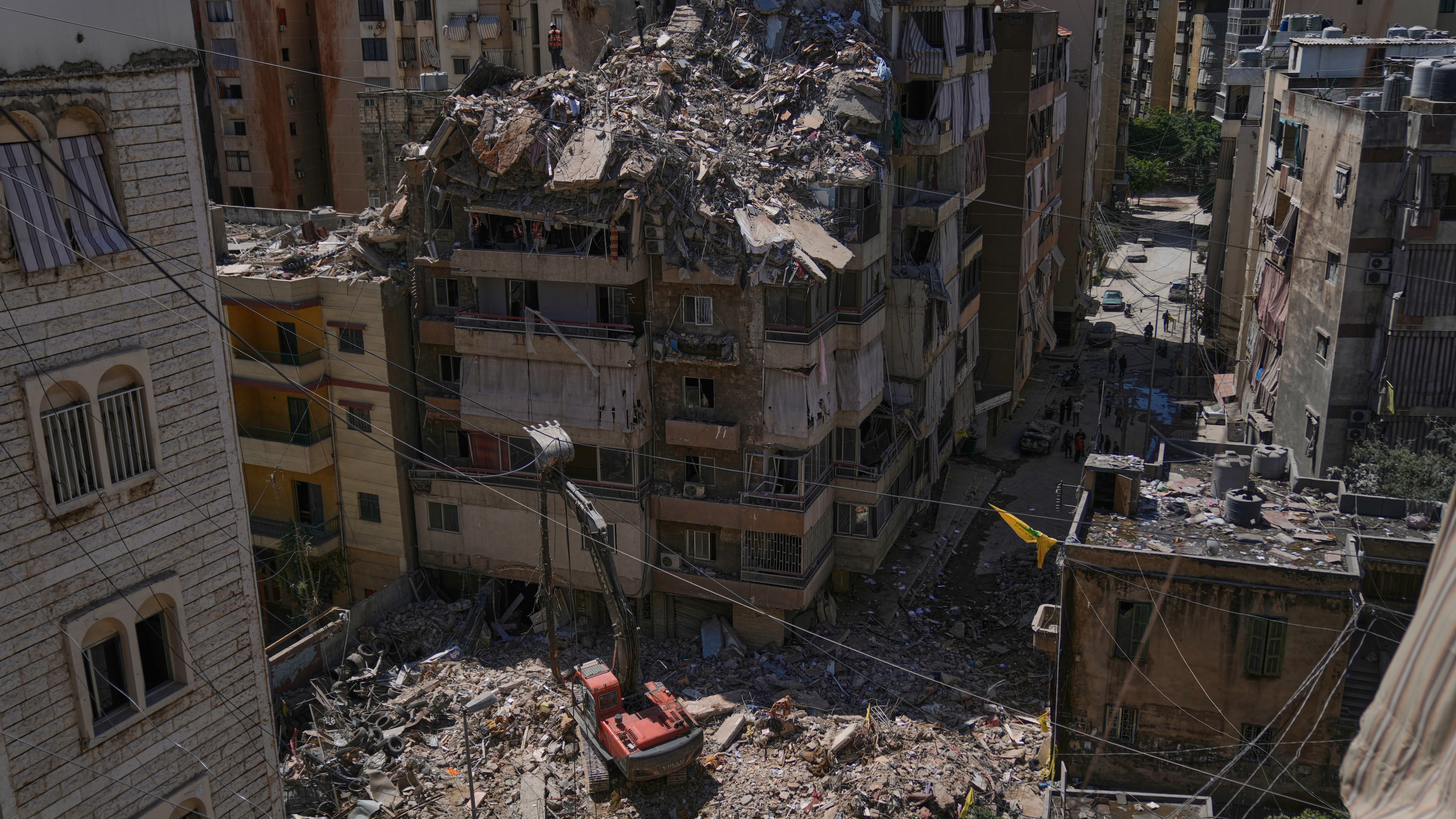 Rescue workers search through the rubble of a building destroyed in an Israeli airstrike the previous day in Dahiyeh, Beirut's southern suburbs, Lebanon, Thursday, May 7, 2026. (AP Photo/Bilal Hussein)