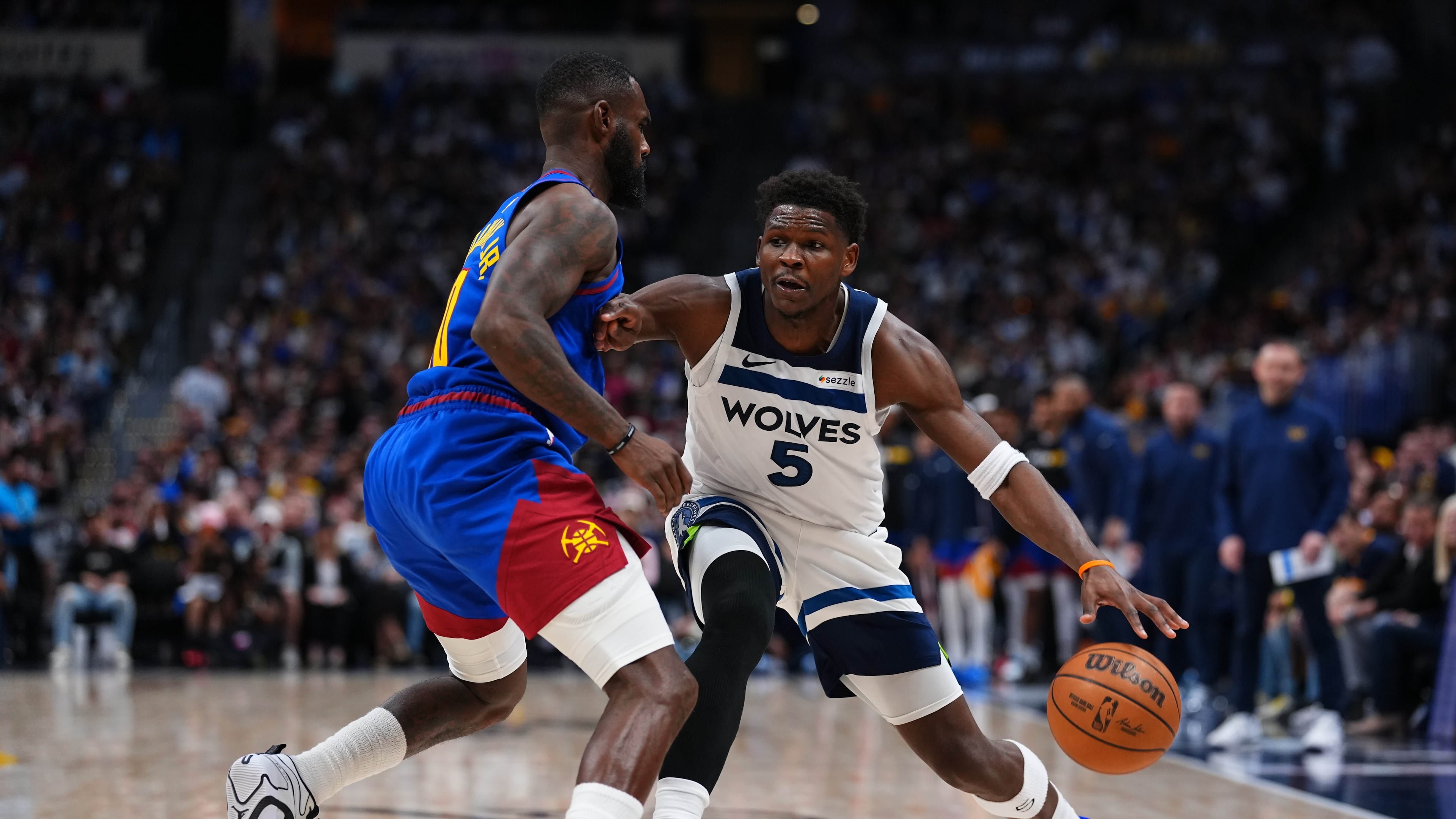Minnesota Timberwolves guard Anthony Edwards (5) drives to the basket against Denver Nuggets guard Tim Hardaway Jr. (10) during the second half in Game 2 of a first-round NBA playoffs basketball series Monday, April 20, 2026, in Denver. (AP Photo/Jack Dempsey)