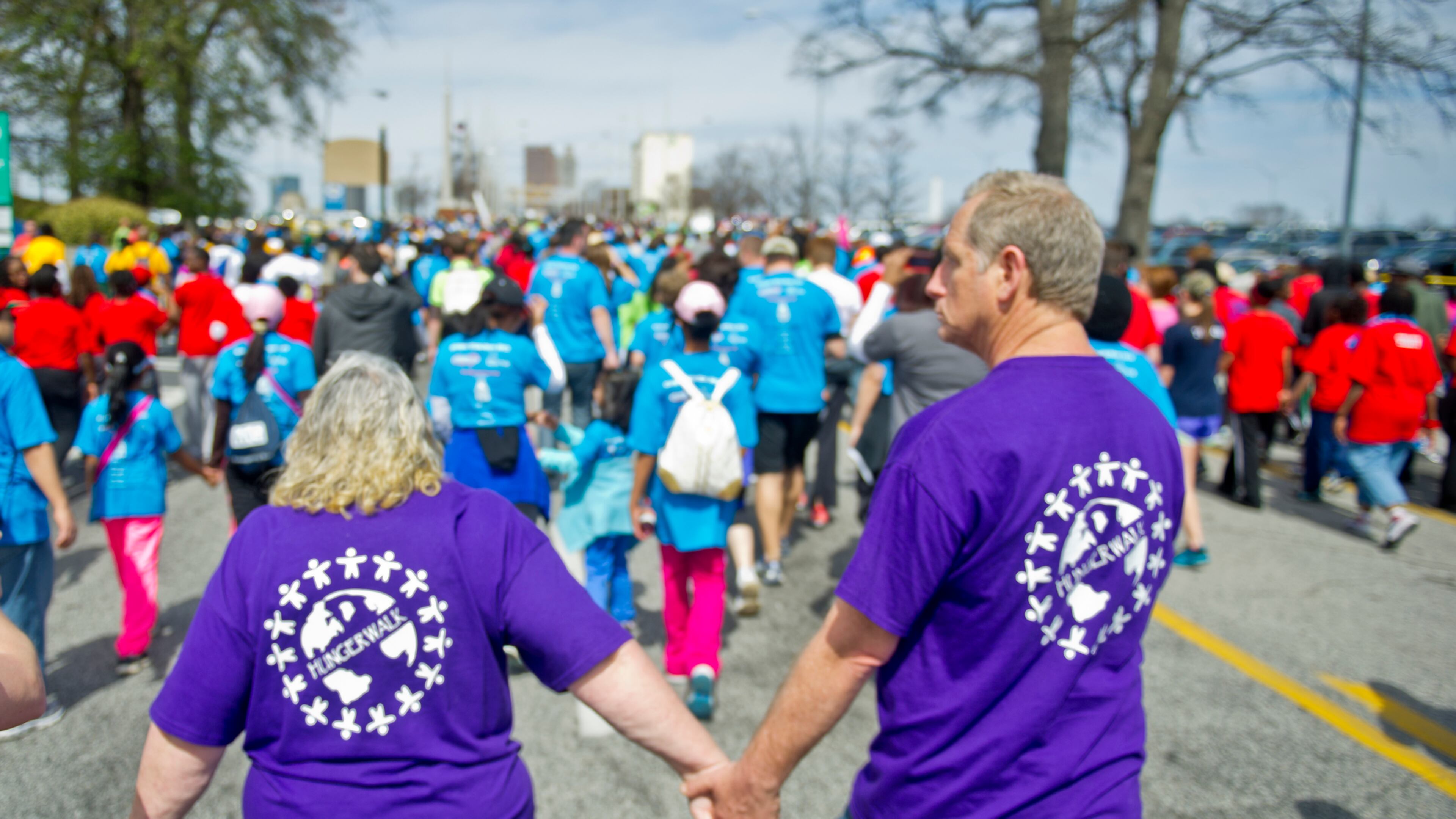 June Woodside (left) holds hands with Donald Palguta as they walk in the Hunger Walk/Run 2013.