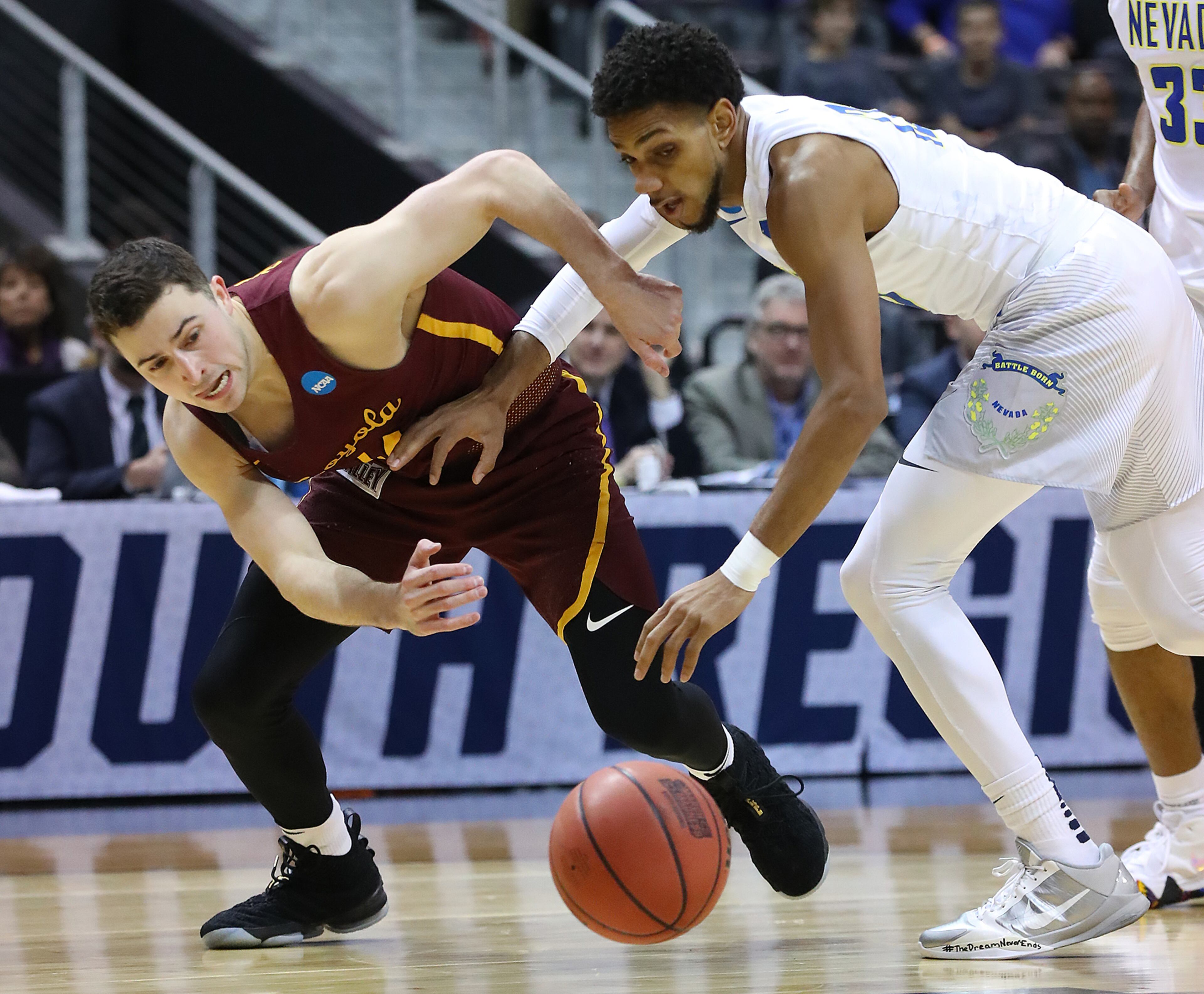 March 22, 2018 Atlanta: Loyola guard Ben Richardson and Nevada guard Hallice Cooke battle for a loose ball during the first half of a regional semifinal NCAA college basketball game on Thursday, March 22, 2018, in Atlanta. Curtis Compton/ccompton@ajc.com