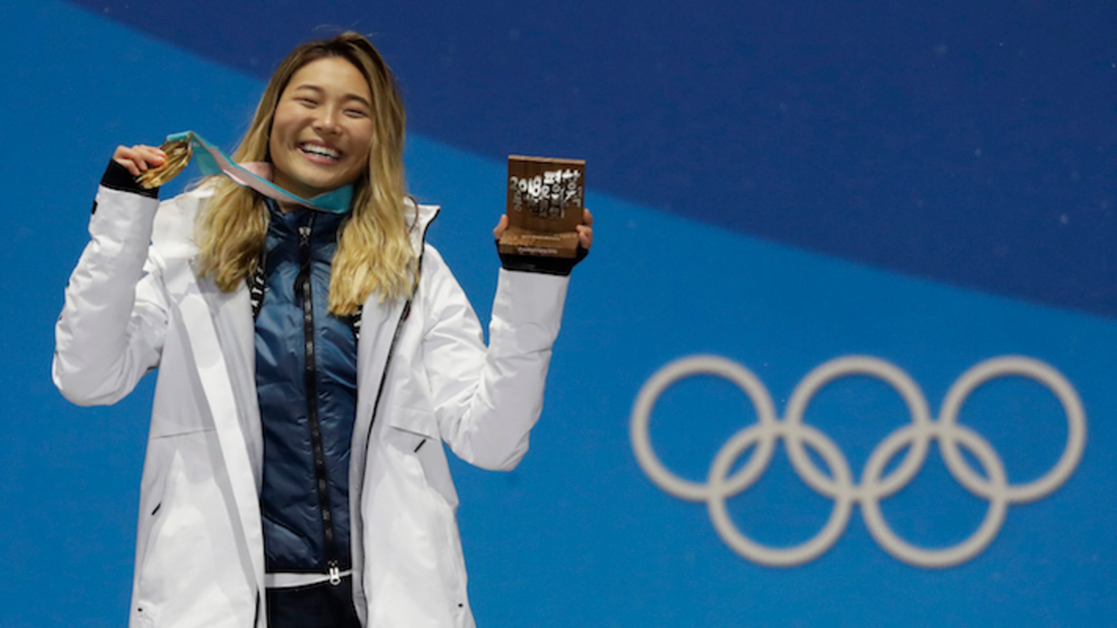 Women's halfpipe gold medalist Chloe Kim, of the United States, poses during the medals ceremony at the 2018 Winter Olympics in Pyeongchang, South Korea, Tuesday, Feb. 13, 2018. (AP Photo/Morry Gash)