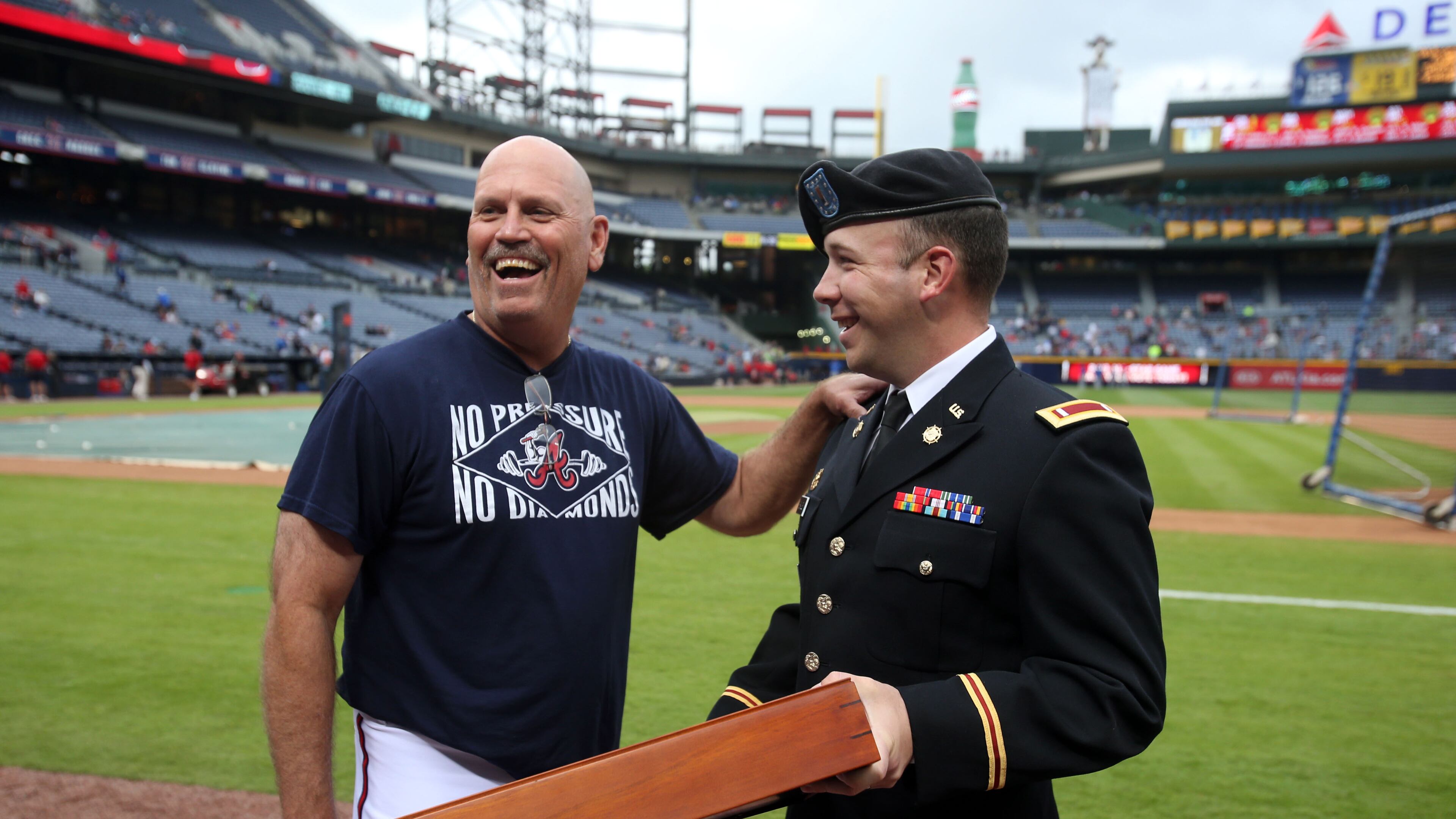 May 3, 2013 - Atlanta, Ga: U.S. Army 1st Lt. Eric Bagley, of Rockdale County, right, presents Atlanta Braves third base coach Brian Snitker with a U.S. flag after Bagley returned from a 9-month service in Afghanistan before the Braves host the New York Mets at Turner Field Friday night in Atlanta, Ga., May 3, 2013. Bagley presented Snitker with the flag for his appreciation and support after Bagley was invited to meet the team by Snitker for 2012 Spring Training. JASON GETZ / JGETZ@AJC.COM