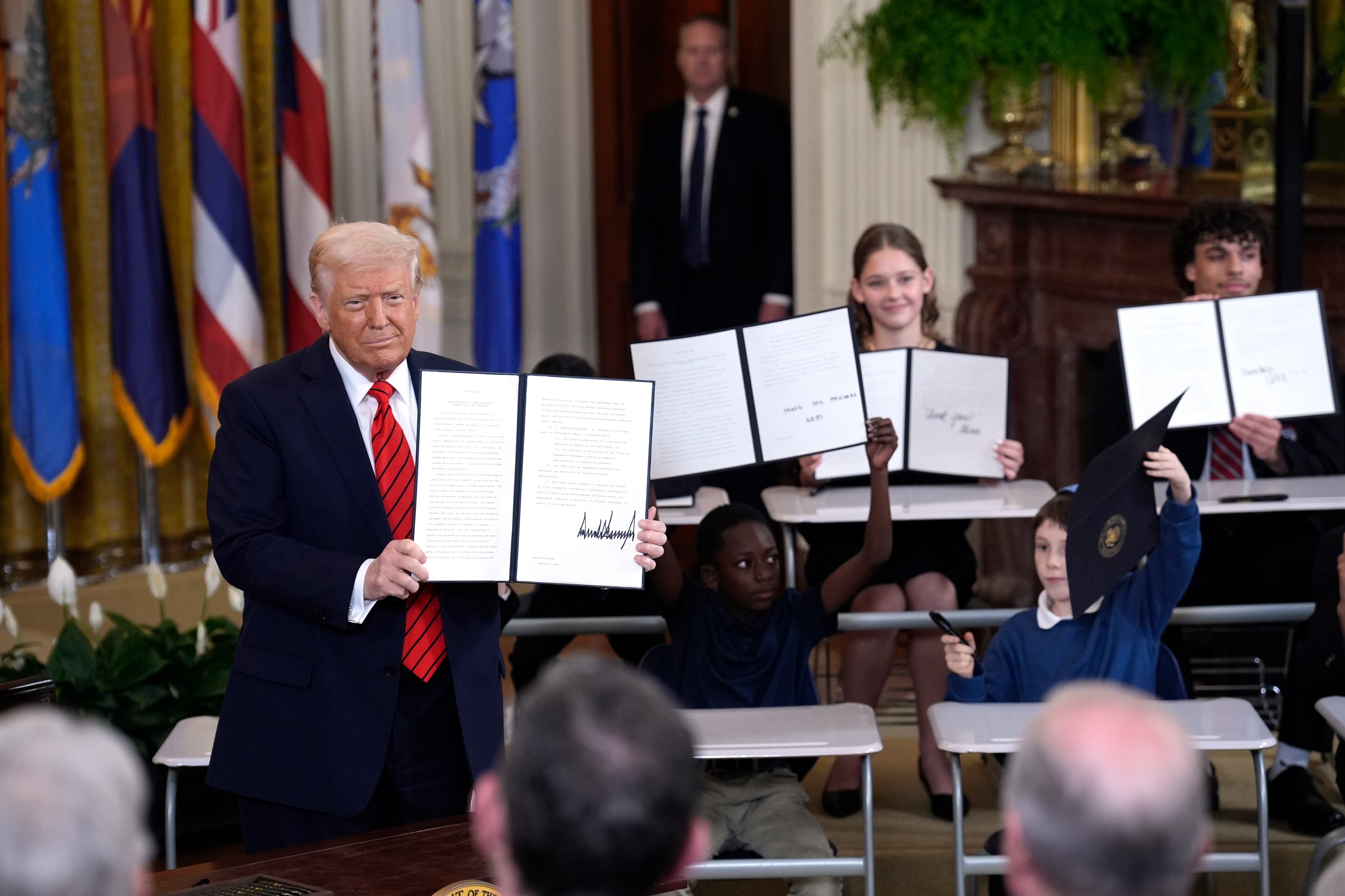 President Donald Trump signs an executive order to shut down the Department of Education during an event in the East Room at the White House in Washington, D.C., on Thursday, March 20, 2025. (Yuri Gripas/Abaca Press/TNS)