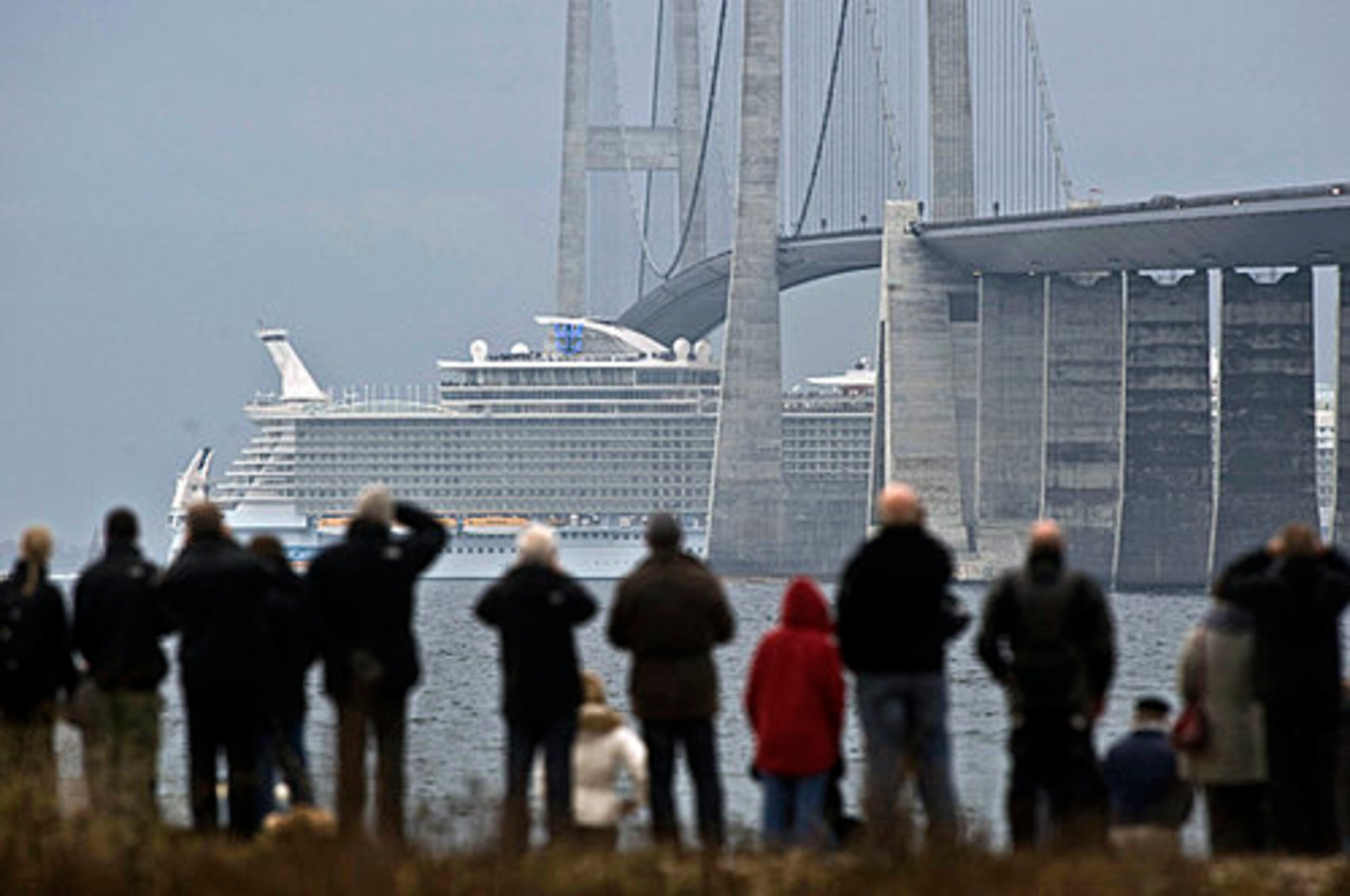 The new cruise ship The Allure of the Seas passed under the Great Belt Fixed Link bridge between the Danish islands of Zealand and Funen across the Great Belt seen from Korsoer in Denmark on Saturday Oct. 30, 2010 as it sails from a shipyard in Turku Finland to Fort Lauderdale, Florida. The sister ship of the world's largest cruise liner has narrowly passed under a Danish bridge, a feat that has required smooth seas and adjustable smokestacks.