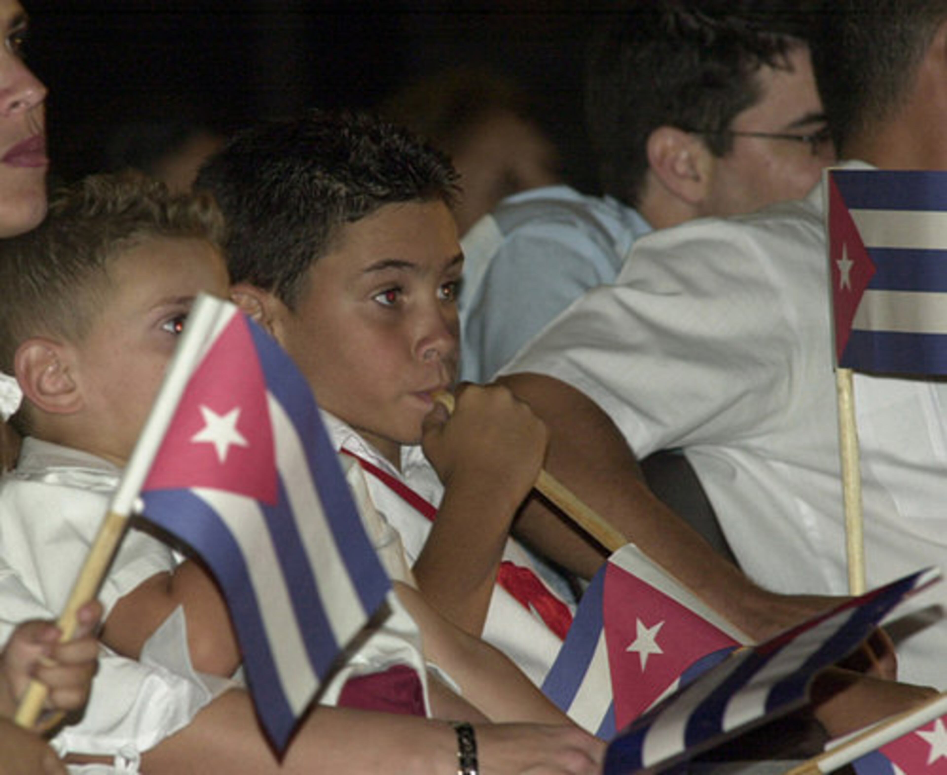 Elian Gonzalez, center, attends a political rally on the fifth anniversary of his return to Cuba, next to his brother Yannis Gonzalez (left), in Havana, Friday April 22, 2005.