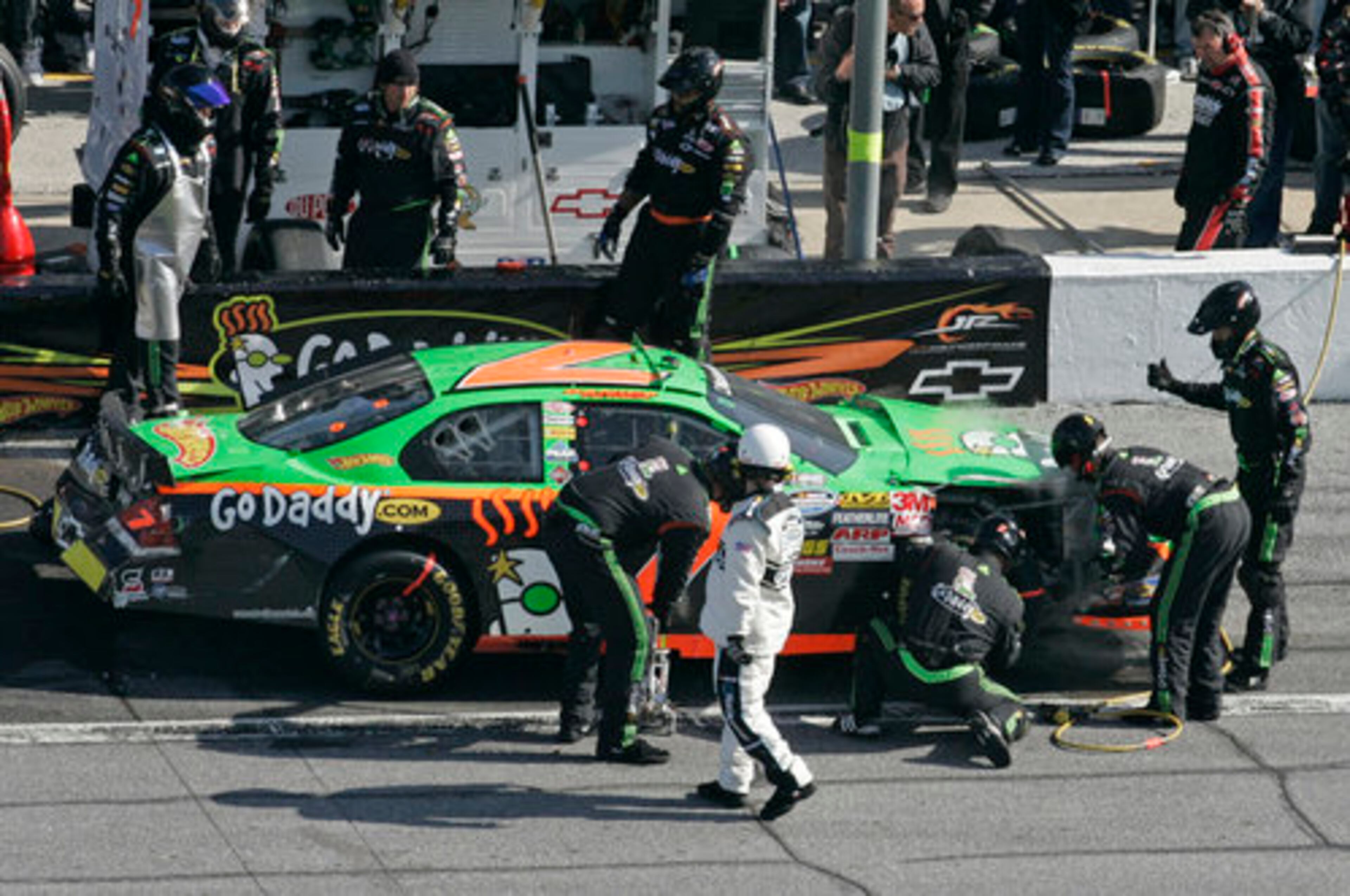 Crew members work on the damaged race car of driver Danica Patrick (7).