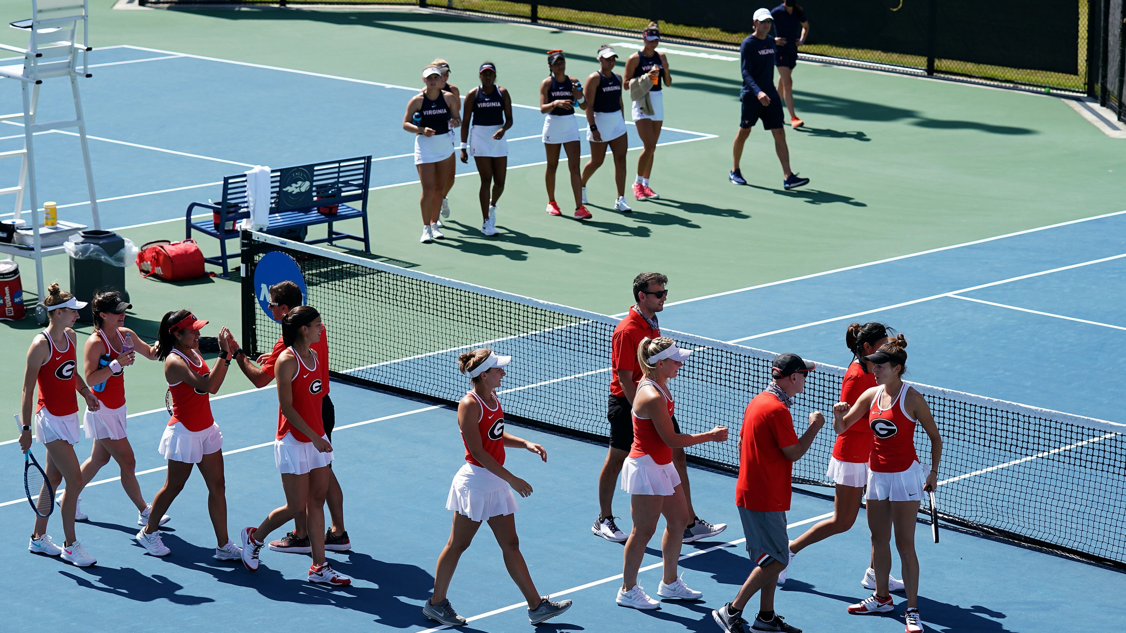 The University of Georgia women's tennis team celebrates after winning the doubles point over Virginia on the the way to a 4-1 victory in the round of 16 at the NCAA Tennis Championships (Manuela Davies/USTA)