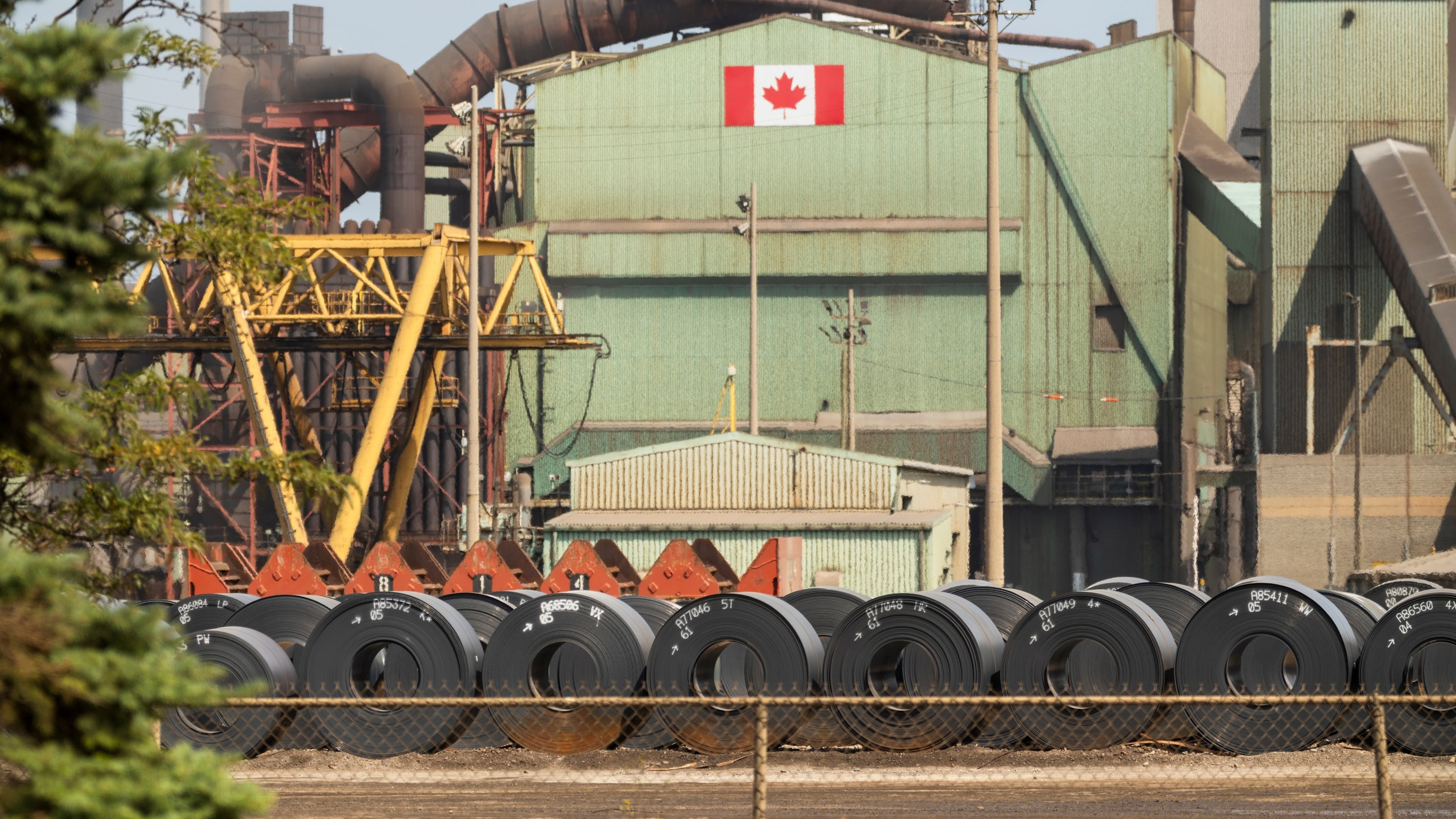 Rolled coils of steel sit in the yard at the ArcelorMittal Dofasco steel plant in Hamilton, Ont. on Thursday, Aug. 20, 2026. (Nick Iwanyshyn /The Canadian Press via AP)