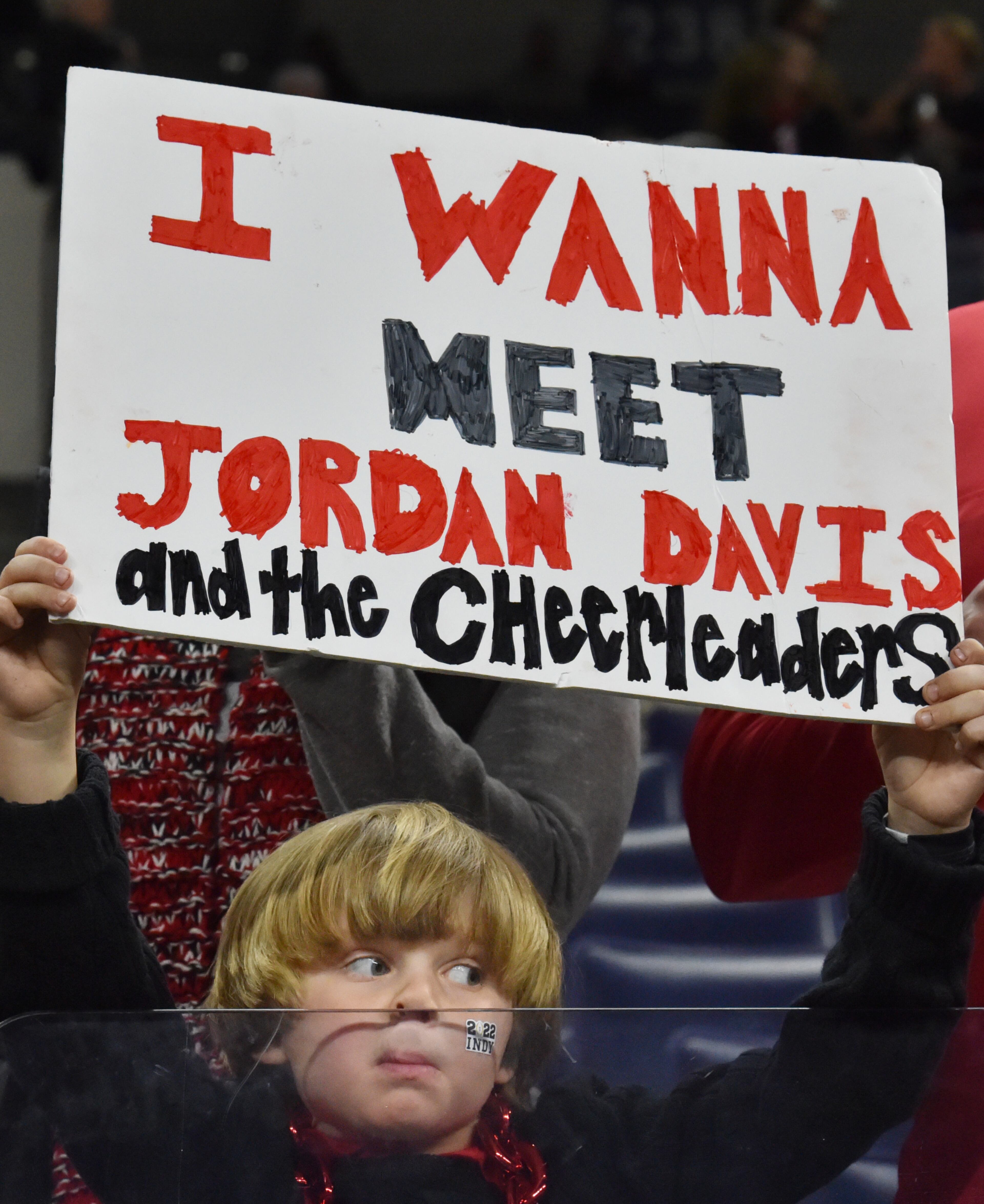 Young Georgia fan holds a sign wishing to meet Jordan Davis in person prior to the 2022 College Football Playoff National Championship Game against Alabama at Lucas Oil Stadium in Indianapolis on Monday, January 10, 2022. (Hyosub Shin / Hyosub.Shin@ajc.com)