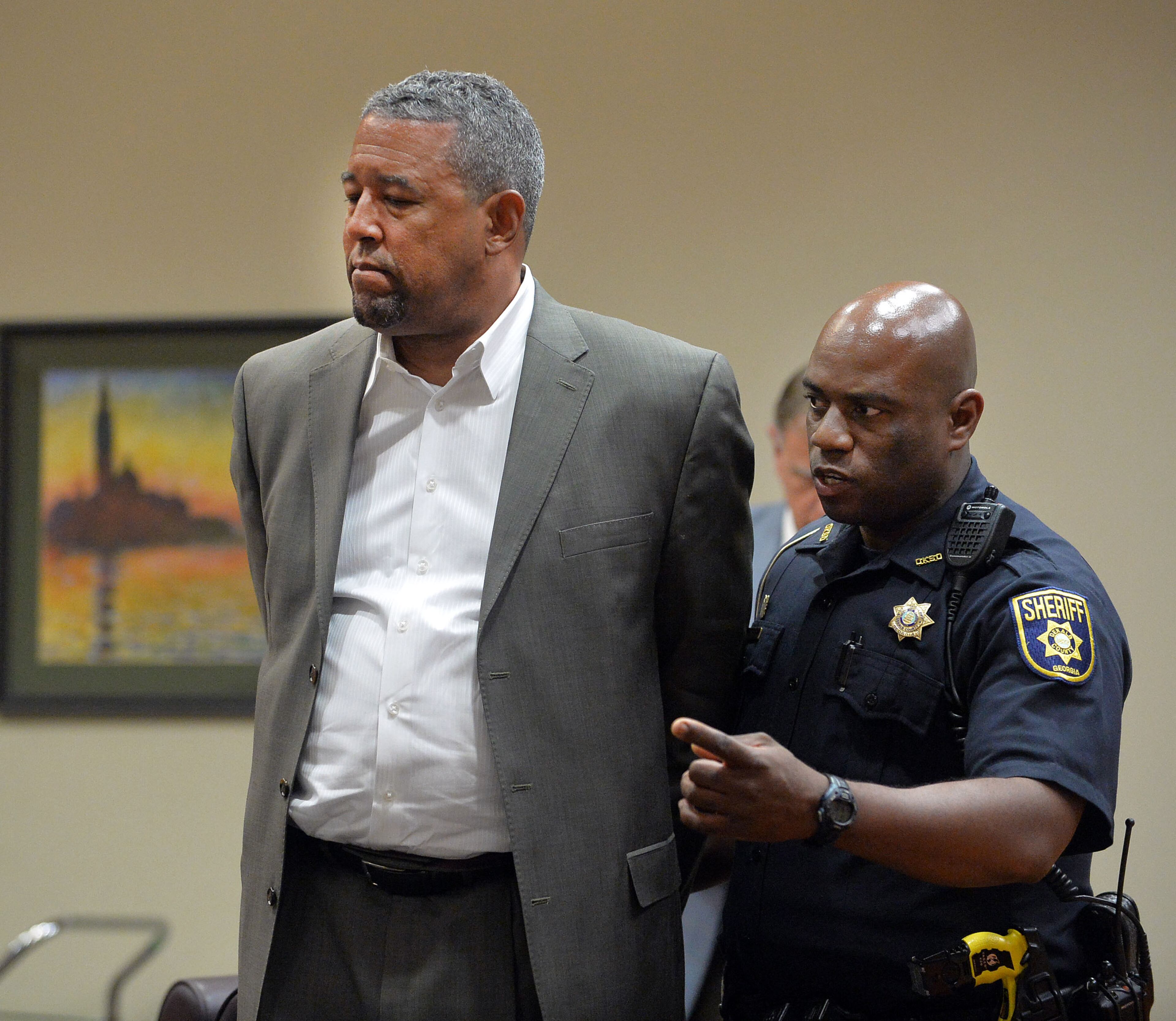 Tony Pope is returned to custody after DeKalb Superior Court Judge Gregory A. Adams signed an arrest warrant following a motions hearing, Tuesday, May 12, 2015. He and Pat Reid are asking for a new trial and petitioning to be released from prison awaiting the trial. KENT D. JOHNSON /KDJOHNSON@AJC.COM