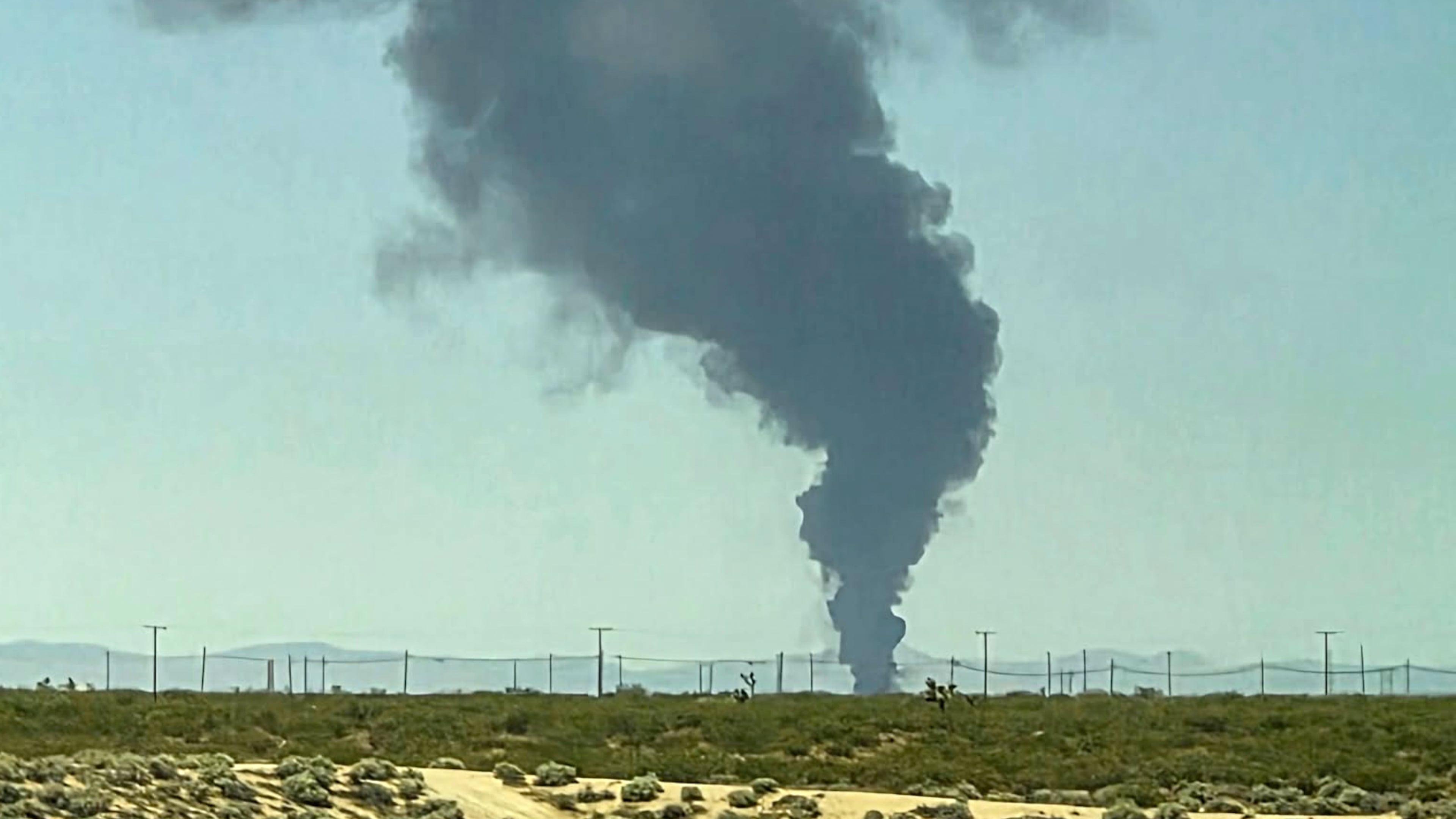 Smoke plumes rise from a B-52 bomber that crashed shortly after takeoff at a U.S. Air Force base in Southern California, Monday, June 15, 2026. (Debbie Reyes Katz via AP Photo)