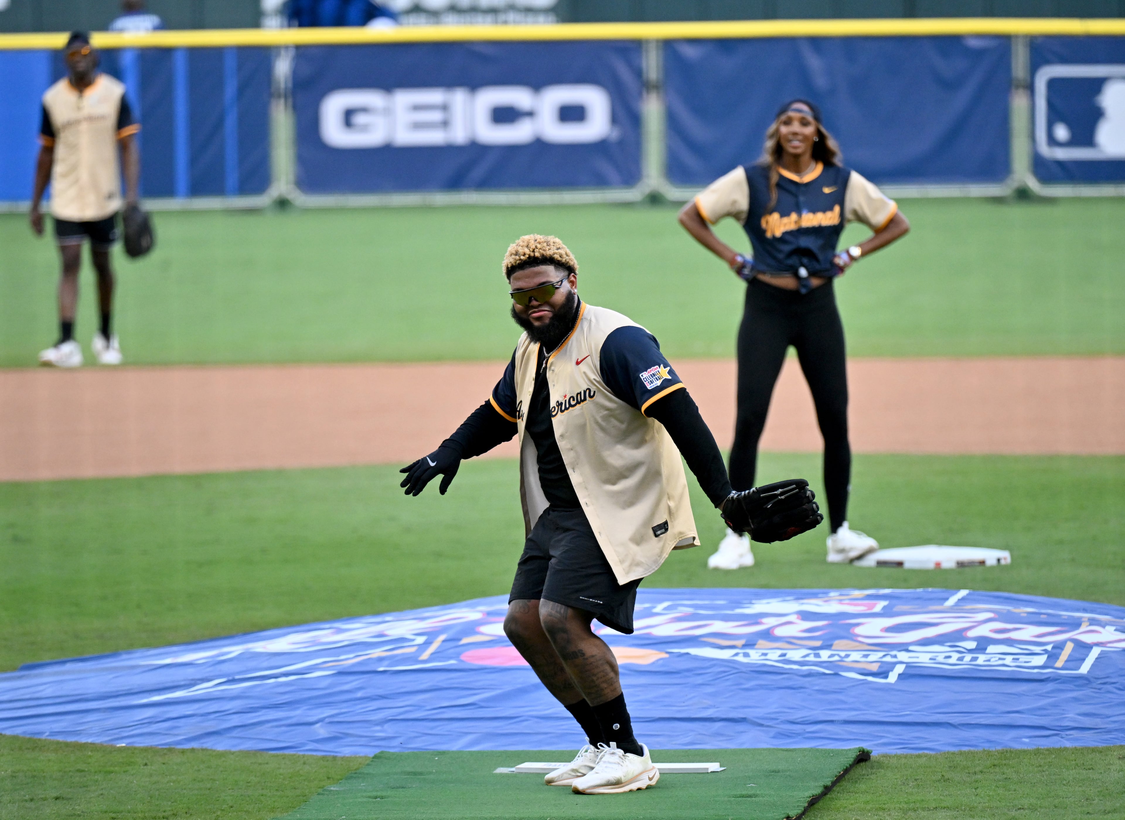 The American League’s Druski, a comedian and actor, dances as he prepares to pitch during the MLB All-Star Celebrity Softball Game at Truist Park on Saturday, July 12, 2025, in Atlanta. (Hyosub Shin/AJC)
