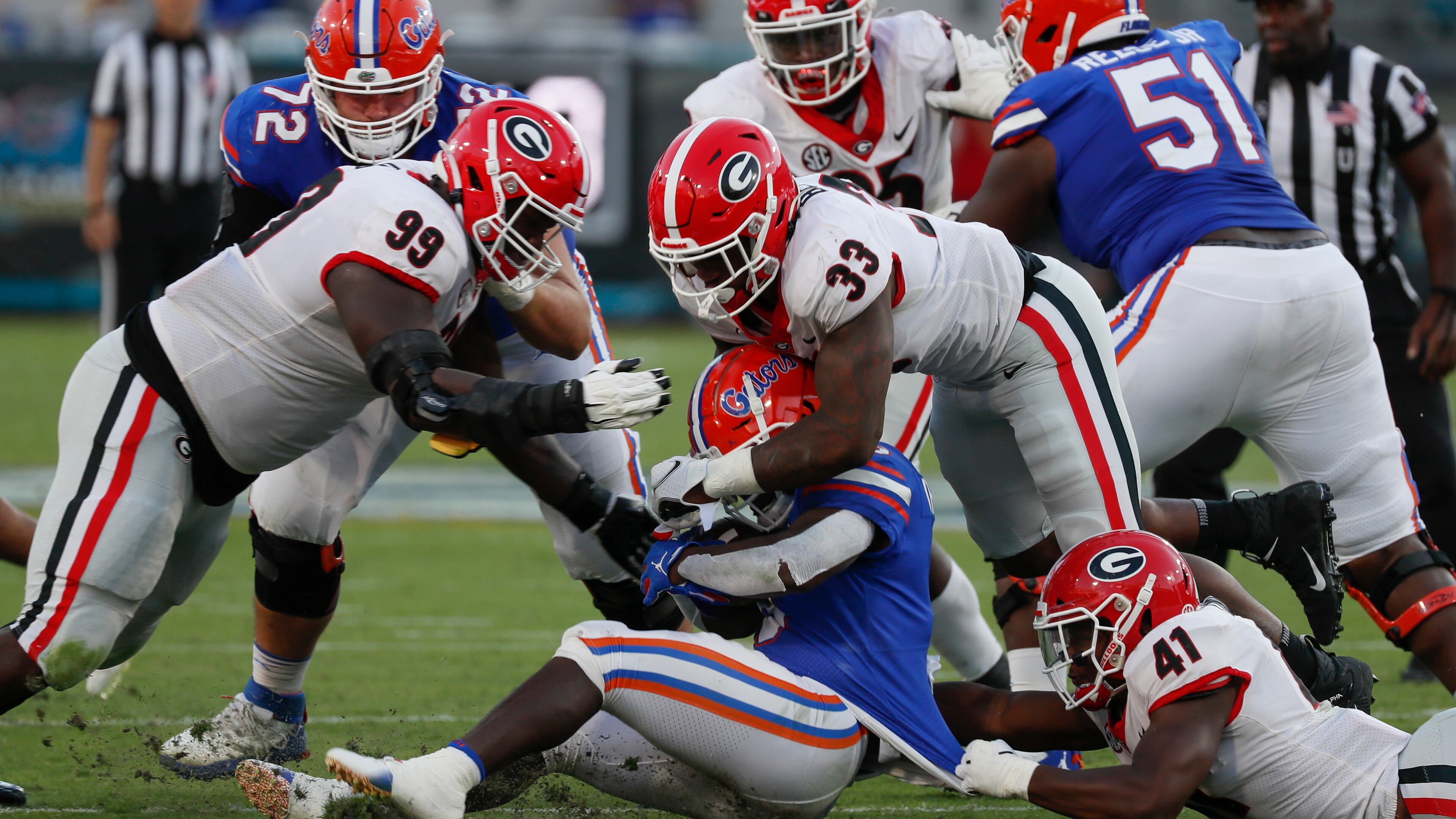 Florida Gators running back Nay'Quan Wright (6) stopped by Georgia Bulldogs defensive lineman Jordan Davis (99),Georgia Bulldogs linebacker Robert Beal Jr. (33) and Georgia Bulldogs linebacker Channing Tindall (41) during the second half of the annual NCCA Georgia vs Florida game at TIAA Bank Field in Jacksonville. Georgia won 34-7. Bob Andres / bandres@ajc.com