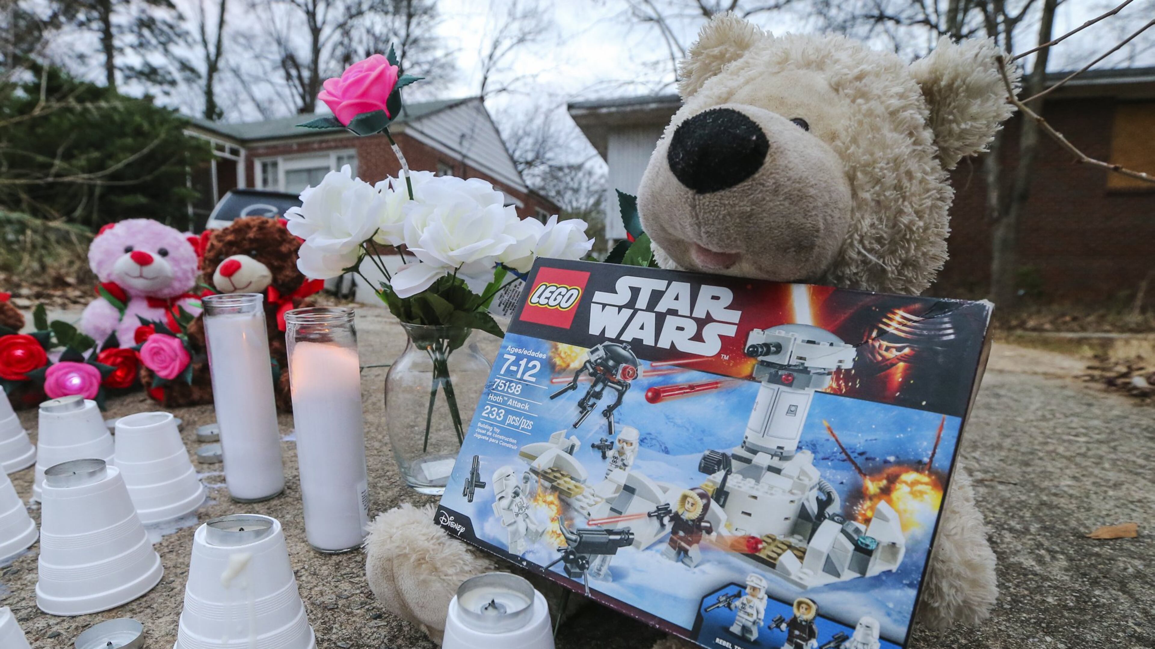 A memorial grew up overnight Tuesday on Jasper Street, near where Logan was killed in a dog attack while on his way to the school bus stop. (AJC file)