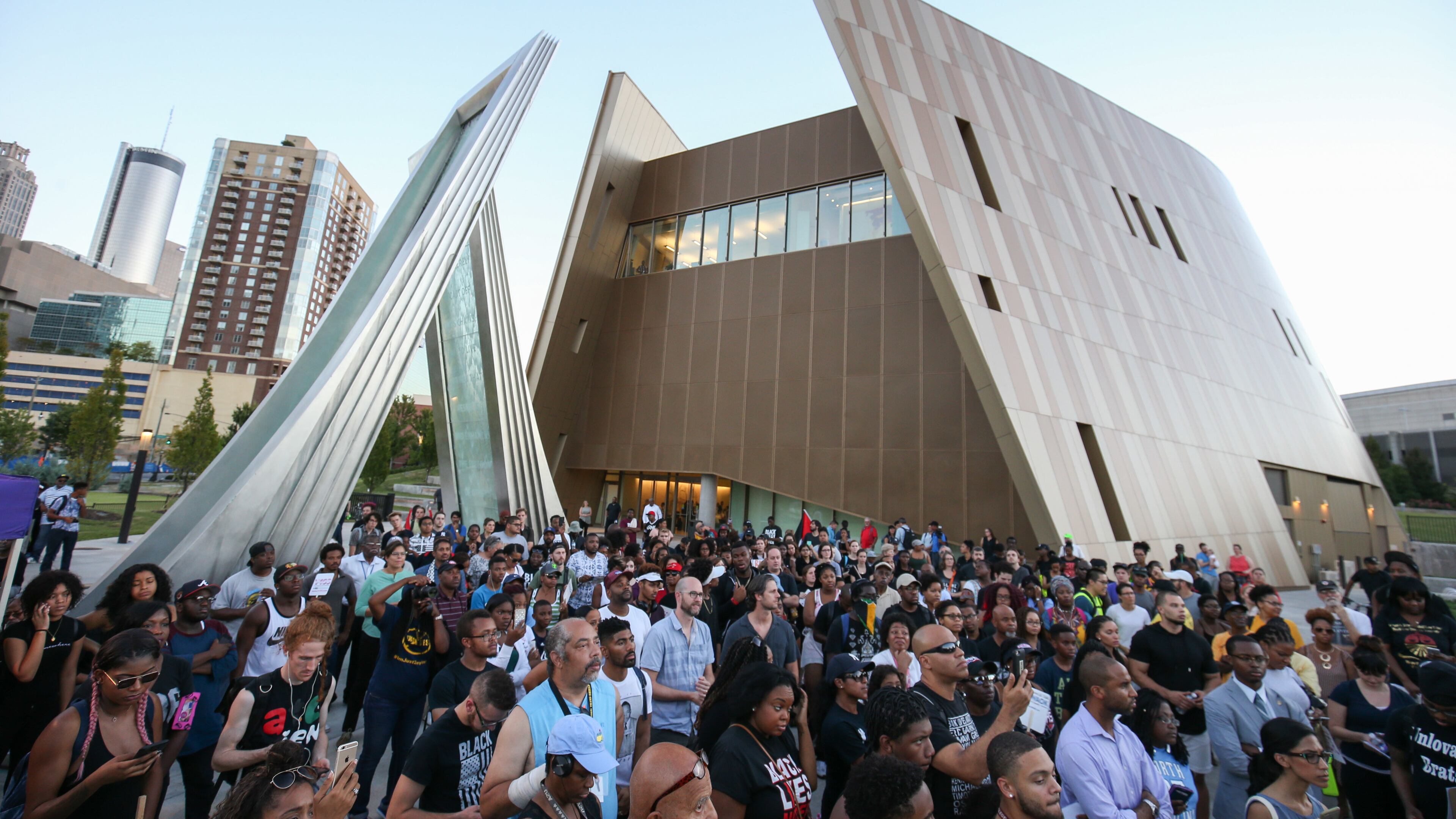 Demonstrators gather at the Center for Civil and Human Rights before marching through downtown Atlanta, Friday, Sept. 23, 2016 in response to the police shooting deaths of Terence Crutch in Tulsa, Okla. and Keith Lamont Scott in Charlotte, N.C. (AP Photo/Branden Camp)
