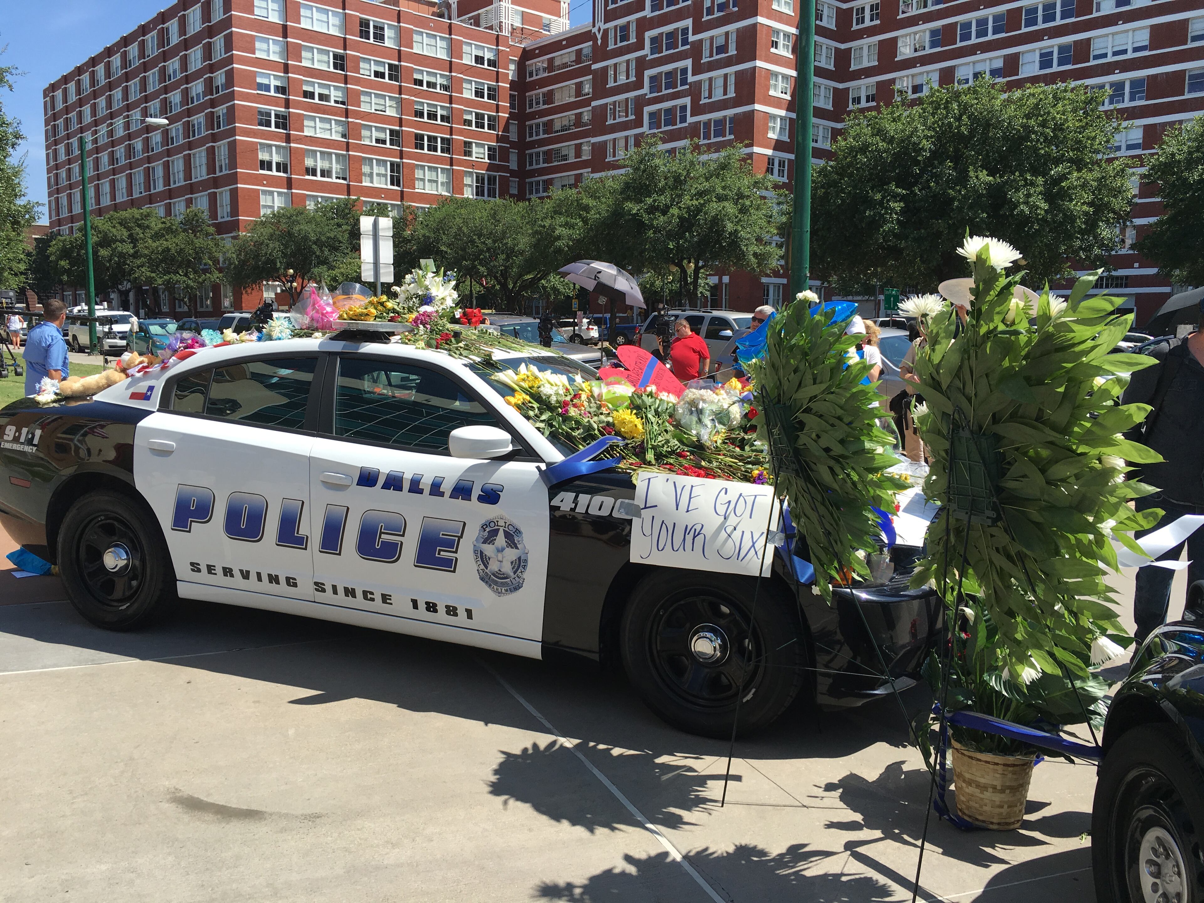 Two Dallas police cruisers parked outside the Dallas police headquarters serve as memorials for the five officers killed Thursday July 7, 2016, after the peaceful Black Lives Matter march turned violent. A gunman shot into the crowd targeting police officers. Tony Plohetski/AMERICAN-STATESMAN