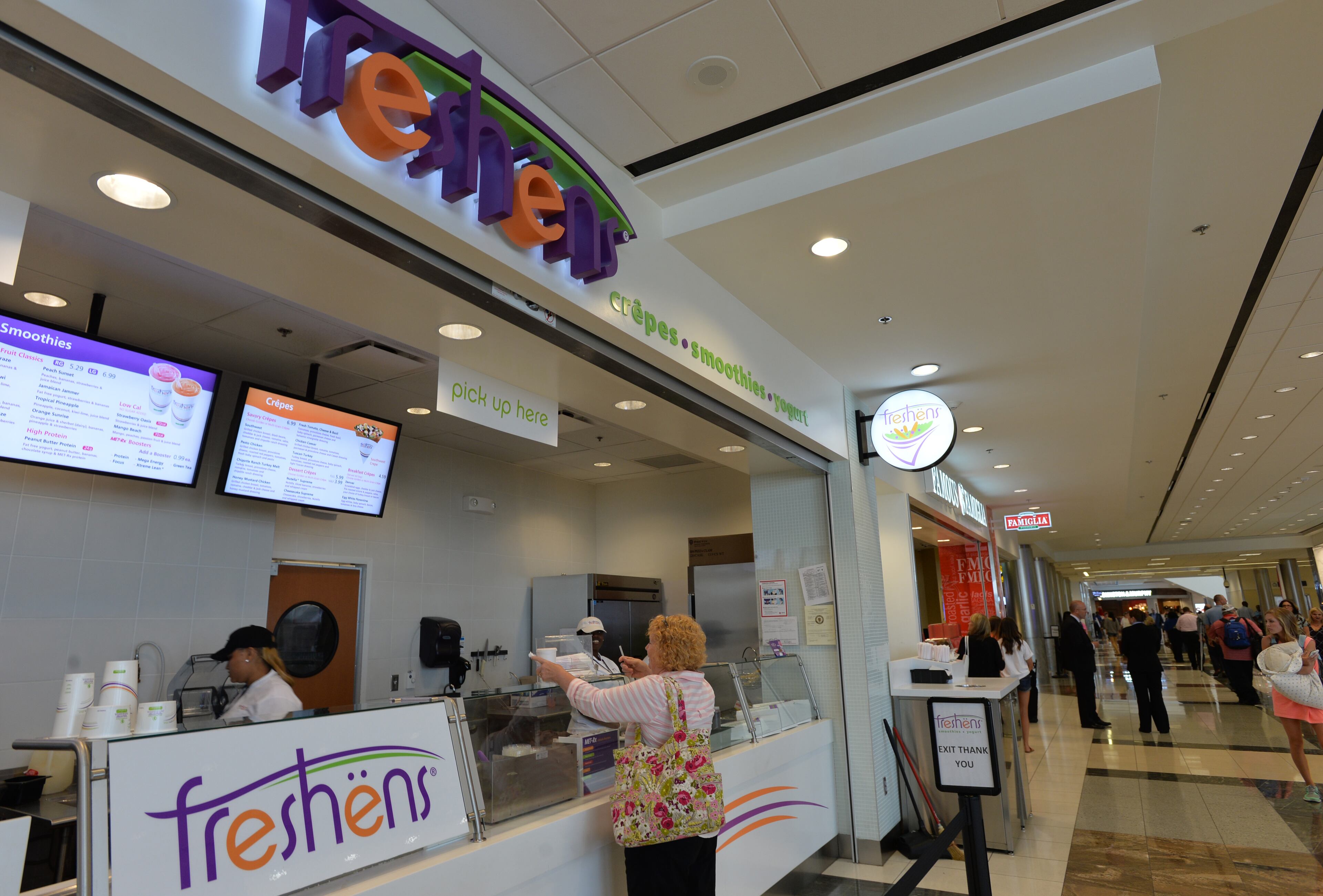 June 24, 2014 Atlanta - Airport travelers at one of newer additions, Freshens, in Concourse D, Hartsfield-Jackson Atlanta International Airport on Tuesday, June 24, 2014. Hartsfield-Jackson and Delaware North celebrate the newest additions to Concourse D, including local favorites GrindHouse Killer Burgers and Yoforia, and national brands 40/40 Club and Food Network Kitchen. HYOSUB SHIN / HSHIN@AJC.COM