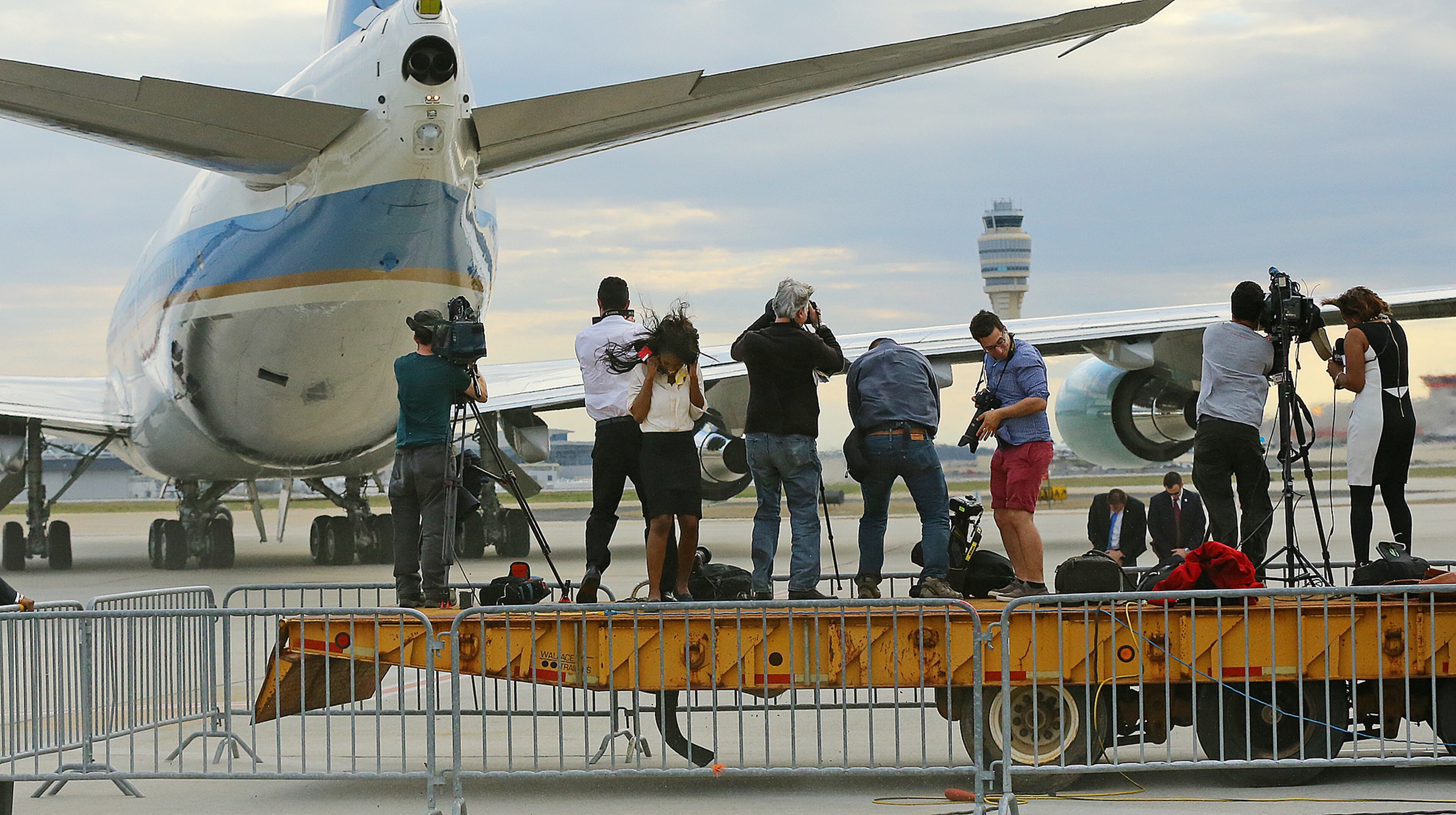 Members of the local news media on a platform are blasted by the jet wash while covering Air Force One leaving with President Barack Obama after his visit on Tuesday, March 10, 2015, in Atlanta. Curtis Compton / ccompton@ajc.com