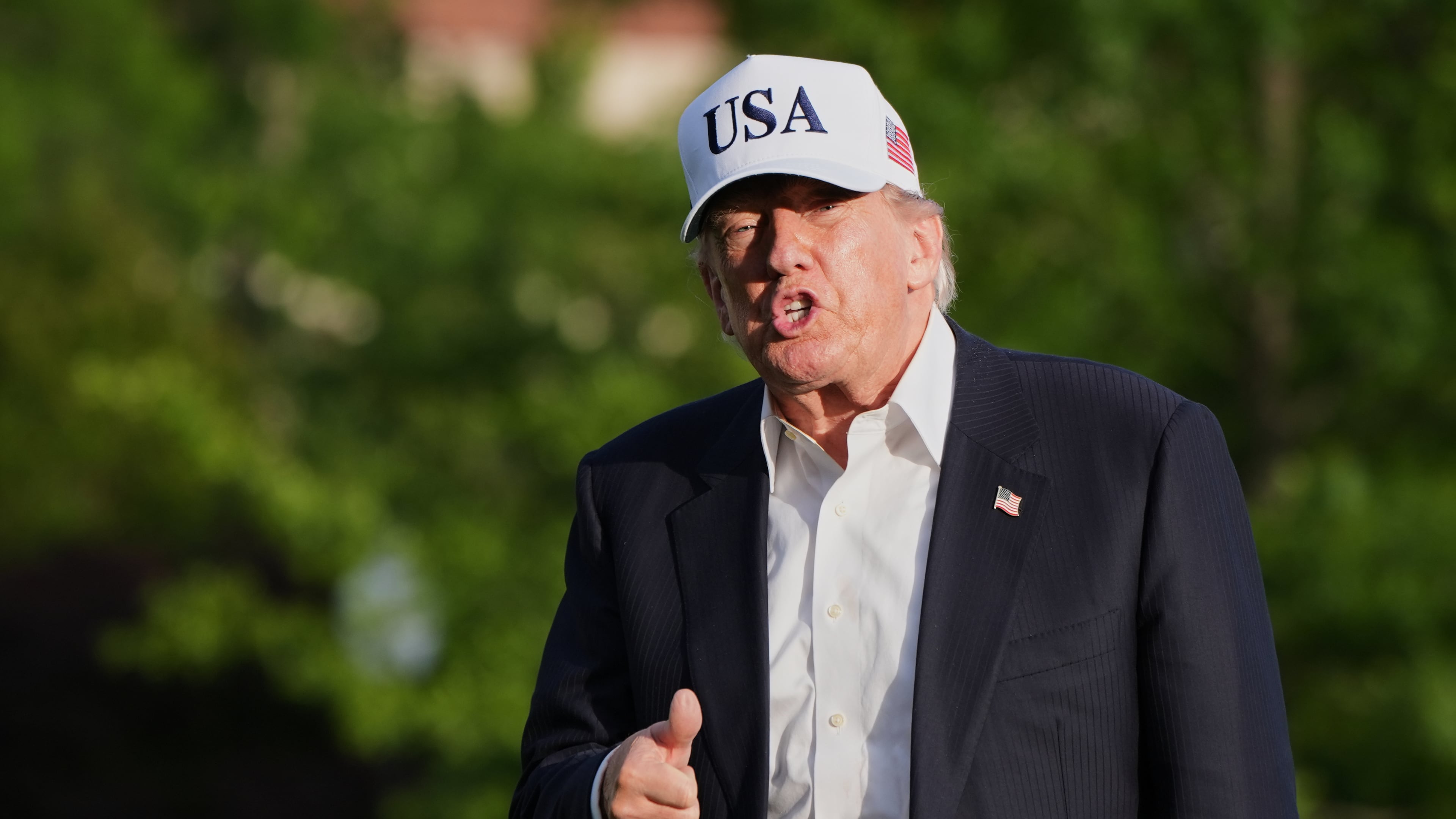 President Donald Trump gestures to reporters as he walks across the South Lawn of the White House, Friday, May 15, 2026, in Washington, on return from Beijing where he met with China's President Xi Jinping. (AP Photo/Jacquelyn Martin)