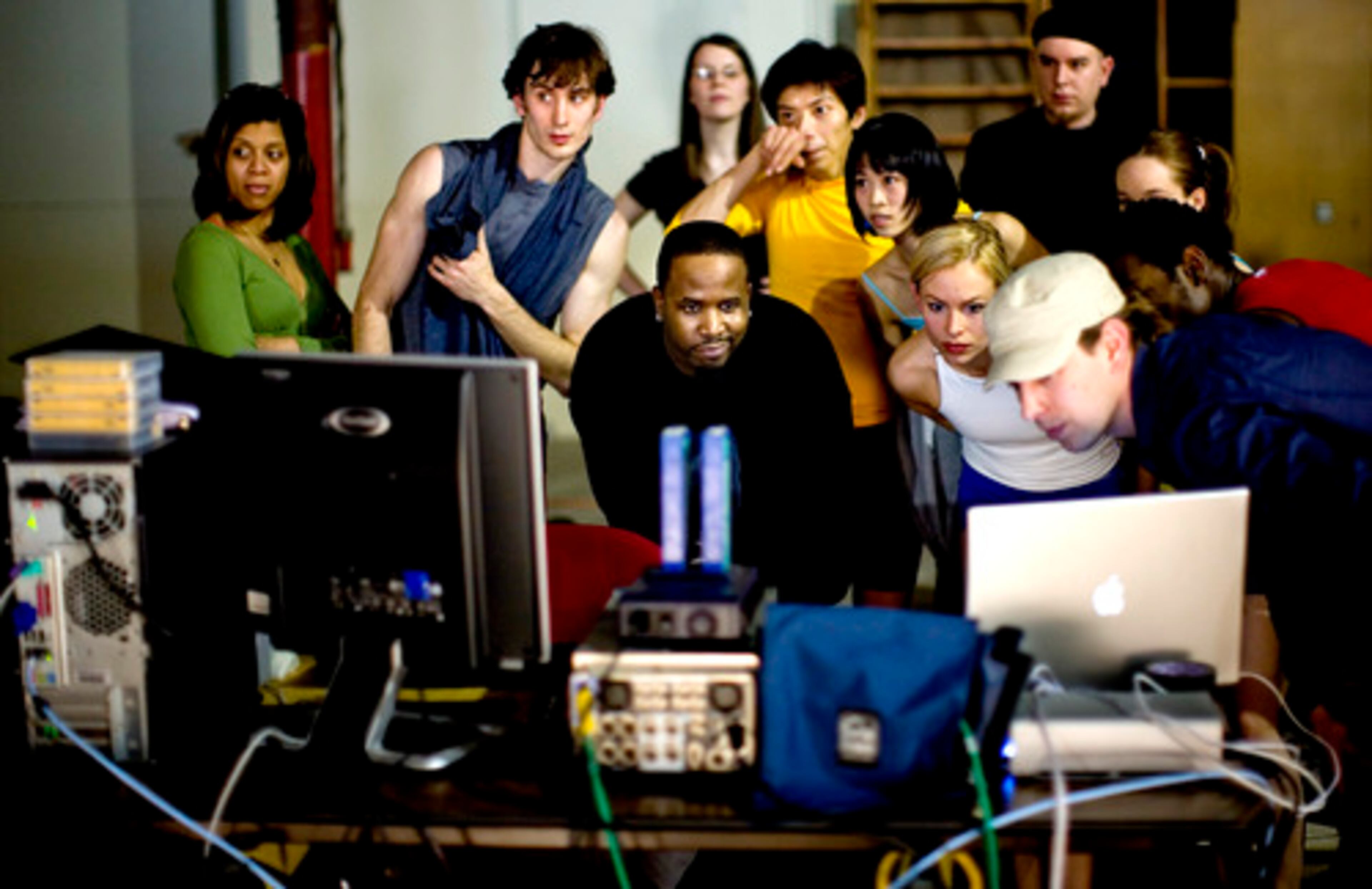 MEMBERS OF "big's" cast and crew review a video of the performance. (Clockwise from front center: Patton, Patton's assistant Marche Butler, Clark, stage manager Amy Icenogle, Li-Chuan Lin, Peng-Yu Chen, lighting director Robert Hand, Rogers, Kantrell, projection designer Adam Larsen and Harshbarger.)