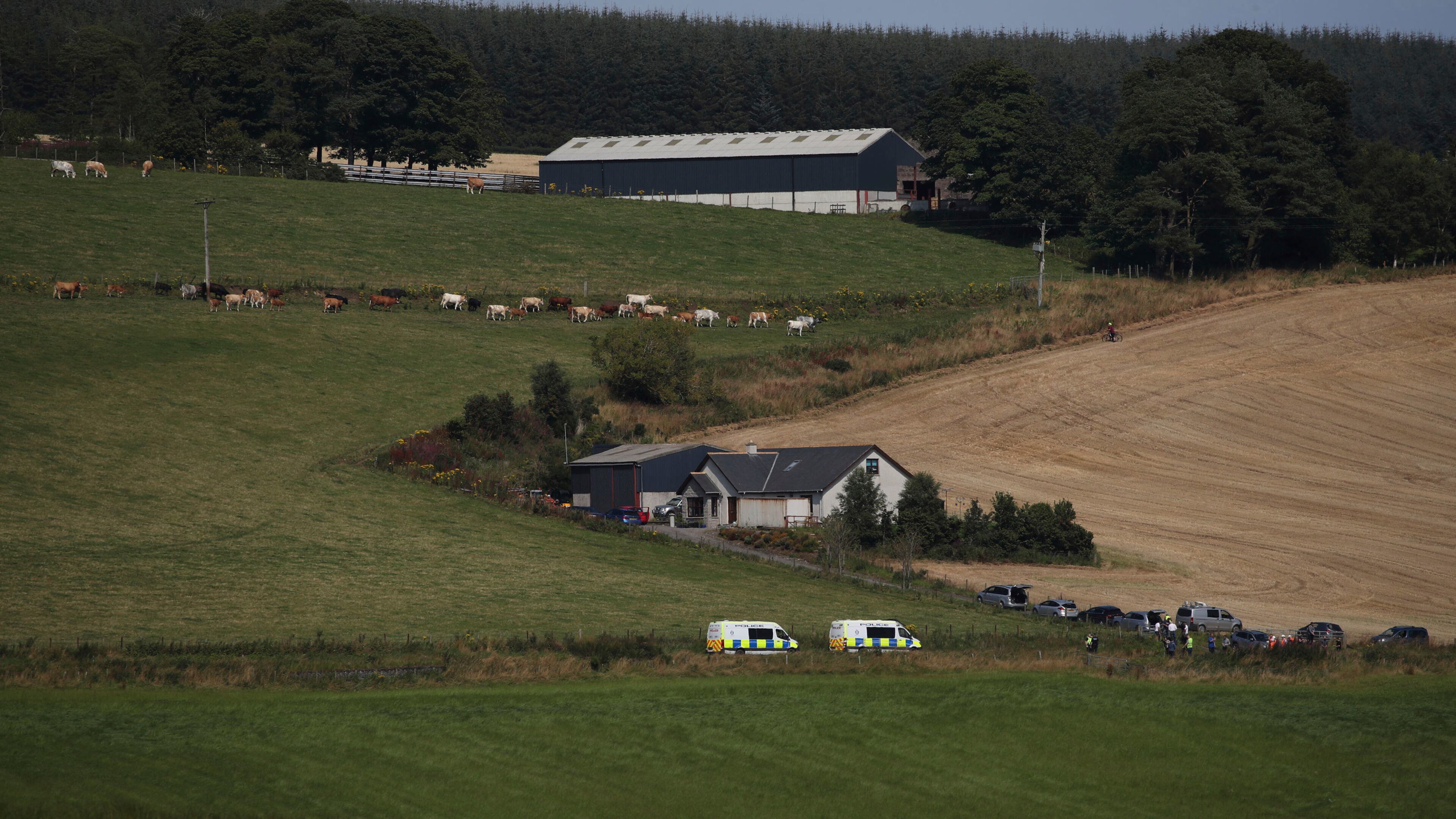 Emergency services personnel gather in Stonehaven, Scotland, near the scene where a train derailed. Police and paramedics were responding Wednesday to a train derailment in northeast Scotland, where smoke could be seen rising from the site. Officials said there were reports of serious injuries. The hilly area was hit by storms and flash flooding overnight.