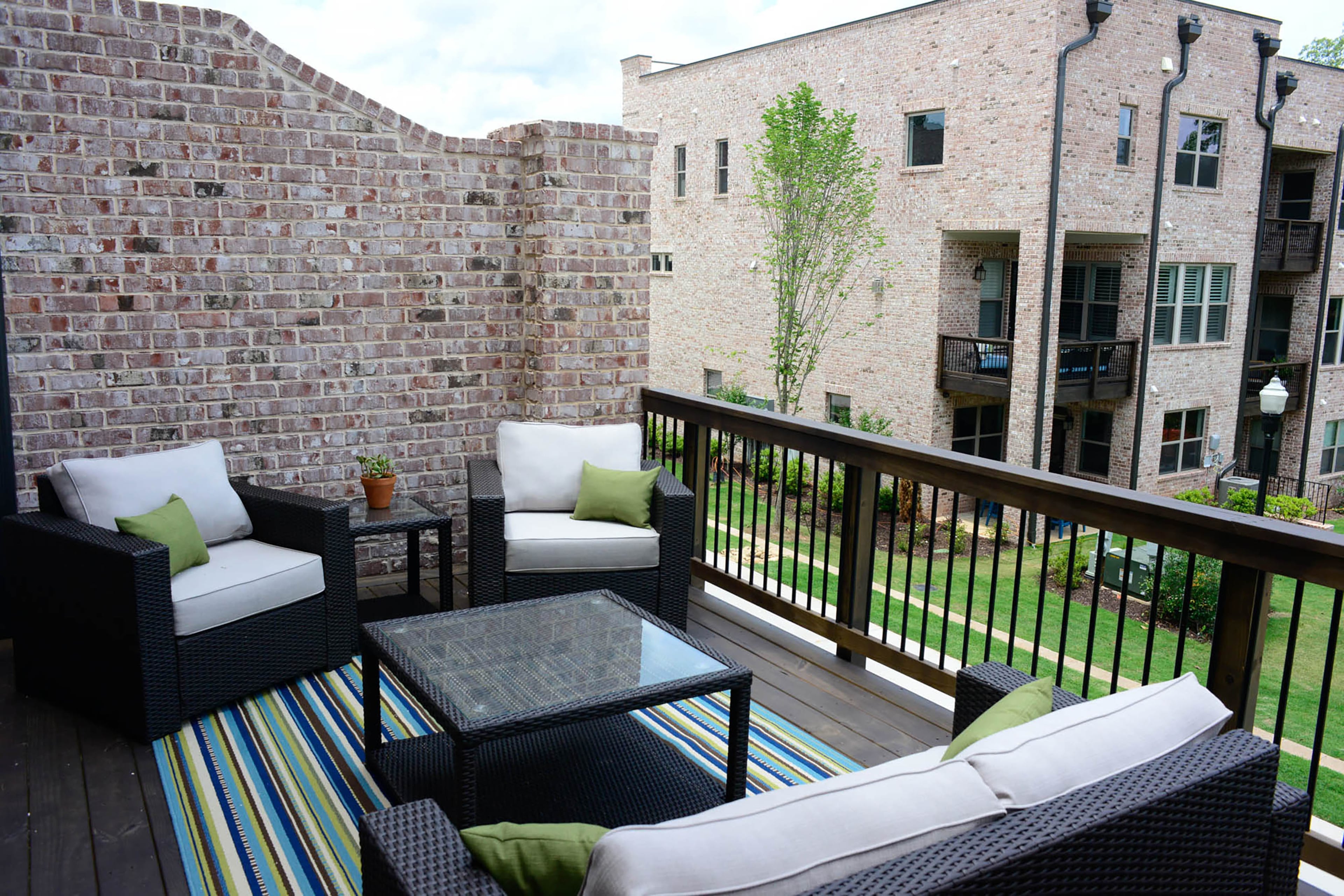 The outdoor deck furniture from At Home features a woven pattern that makes it more durable for all weather. The green pillows accentuate the green in the outdoor rug from Overstock. Gabe Dalusky bought his three bedroom, 3 1/2 bath townhome earlier this year. By purchasing during the building process, Dalusky was able to change and update the design. Captions by Lori Johnston and Kelsey E. Green/Fast Copy News Service.