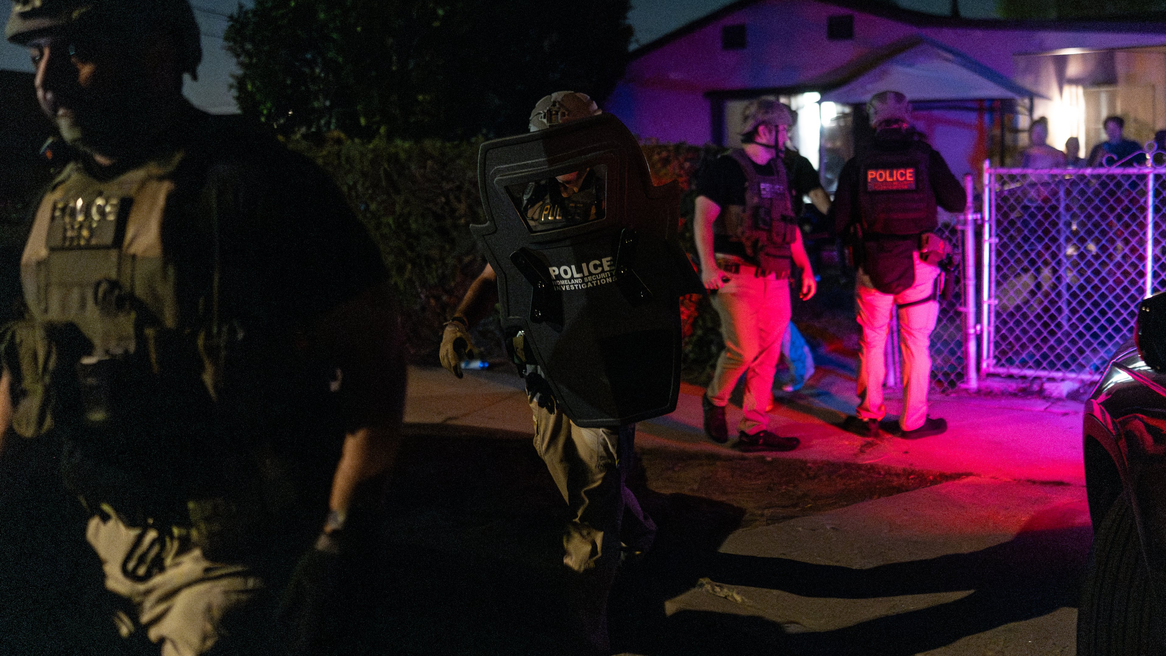 Homeland Security Investigations officers leave a home after arresting a suspect accused of illegally registering to vote during a federal operation in Commerce, Calif., Monday, Oct. 19, 2026. (AP Photo/Jae C. Hong)