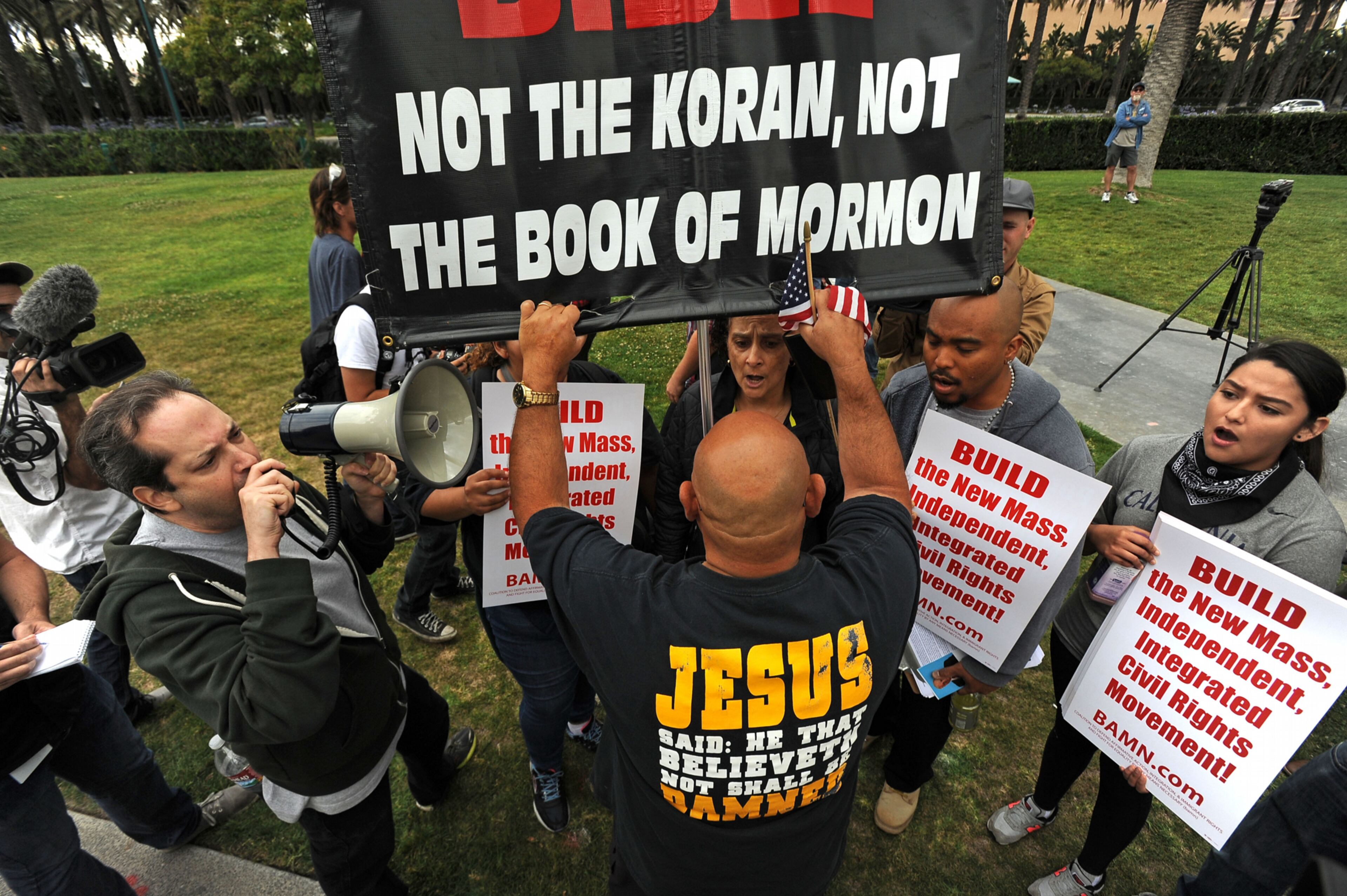 Protesters face-off outside a Donald Trump rally at the Anaheim Convention Center on Wednesday, May 25, 2016 in Anaheim, Calif. A small but vocal group of people protested outside a Donald Trump campaign rally Wednesday in Orange County amid a heavy police presence to guard against a repeat of raucous demonstrations at other Trump events. (Michael Goulding /The Orange County Register via AP)