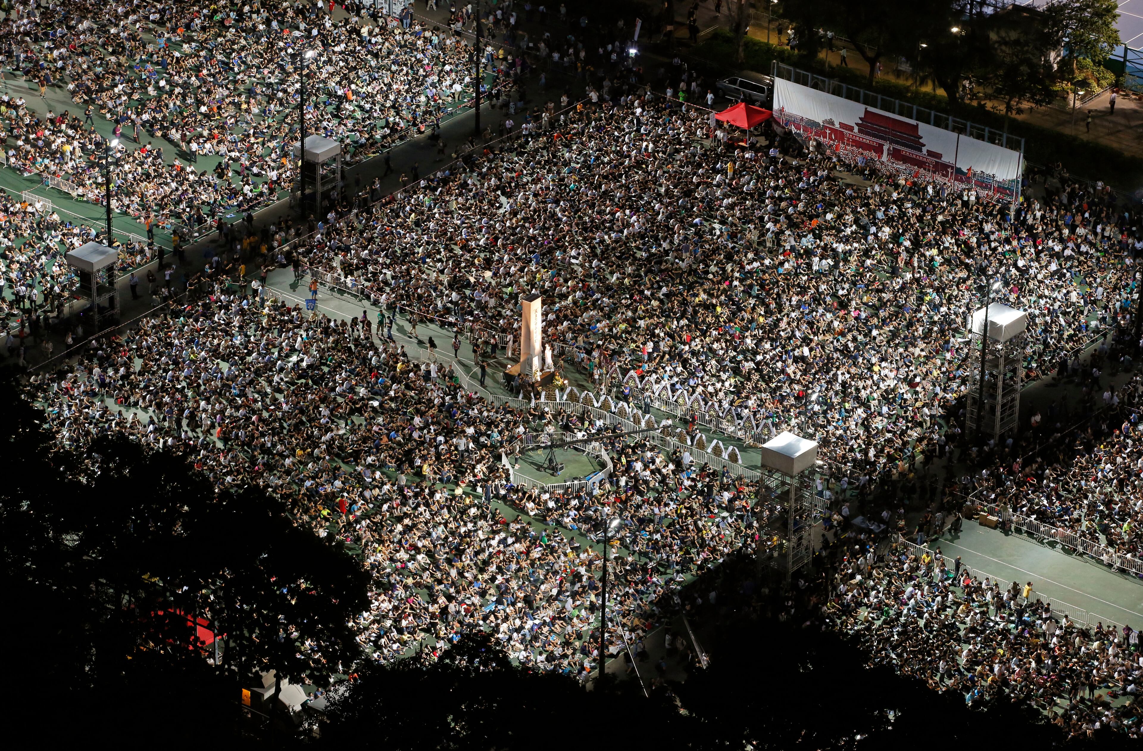 Tens of thousands of people attend a candlelight vigil at Victoria Park in Hong Kong, Thursday, June 4, 2015. Hong Kongers held a candlelight vigil Thursday night to mark the suppression of the 1989 student-led Tiananmen Square protests, an annual event that takes on greater meaning for the city's young after last autumn's pro-democracy demonstrations sharpened their sense of unease with Beijing. (AP Photo/Kin Cheung)