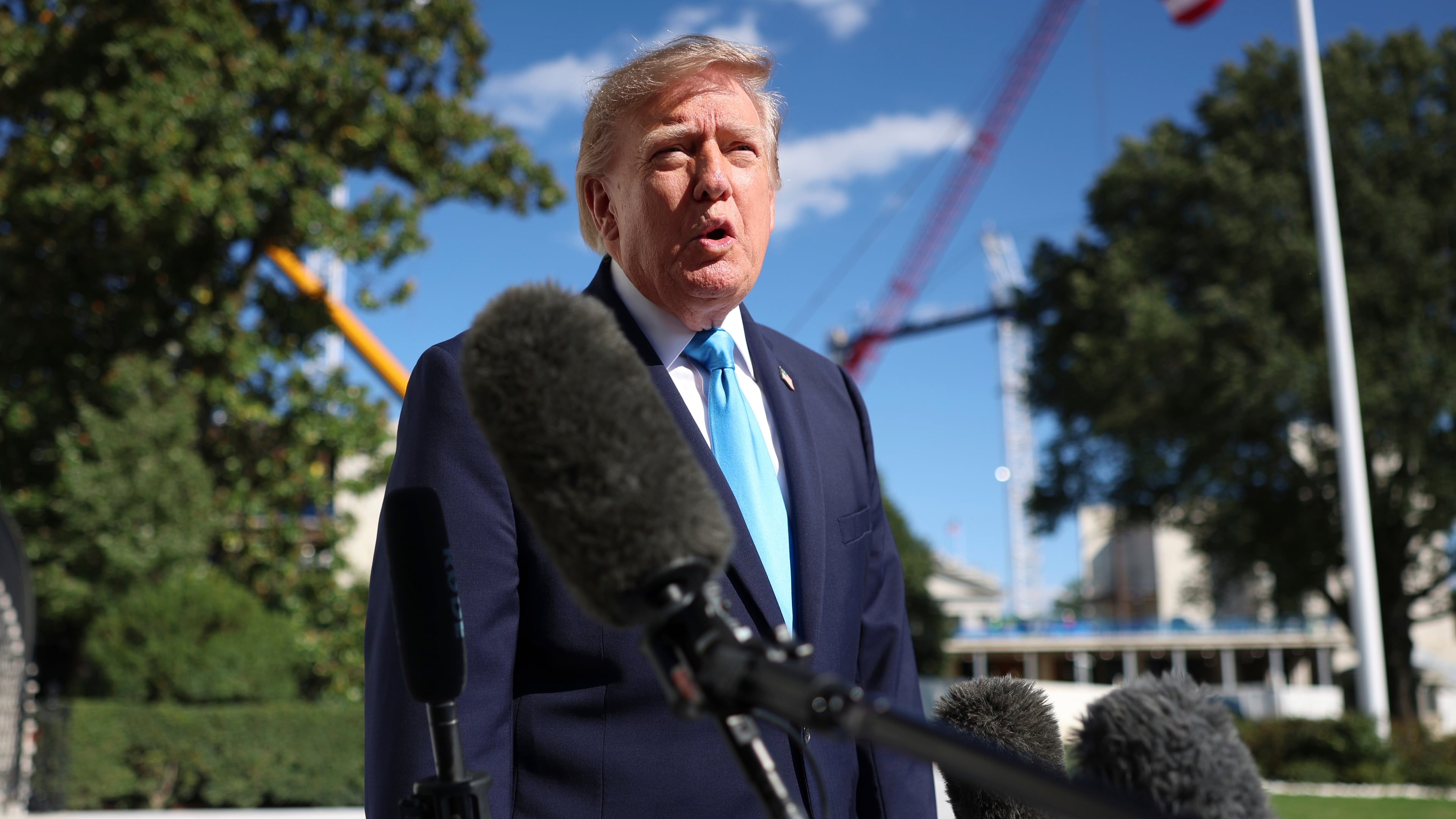 President Donald Trump speaks with reporters before walking to board Marine One on the South Lawn of the White House, Monday, Oct. 5, 2026, in Washington. (AP Photo/Tom Brenner)