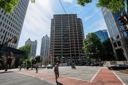 The Campanile building is visible from Peachtree Street NE and 14th Street on Tuesday, May 19, 2026. The well-known Midtown construction site has remained incomplete for years. Local residents are unhappy with the slow progress, and some city officials have taken notice. (Miguel Martinez/AJC)