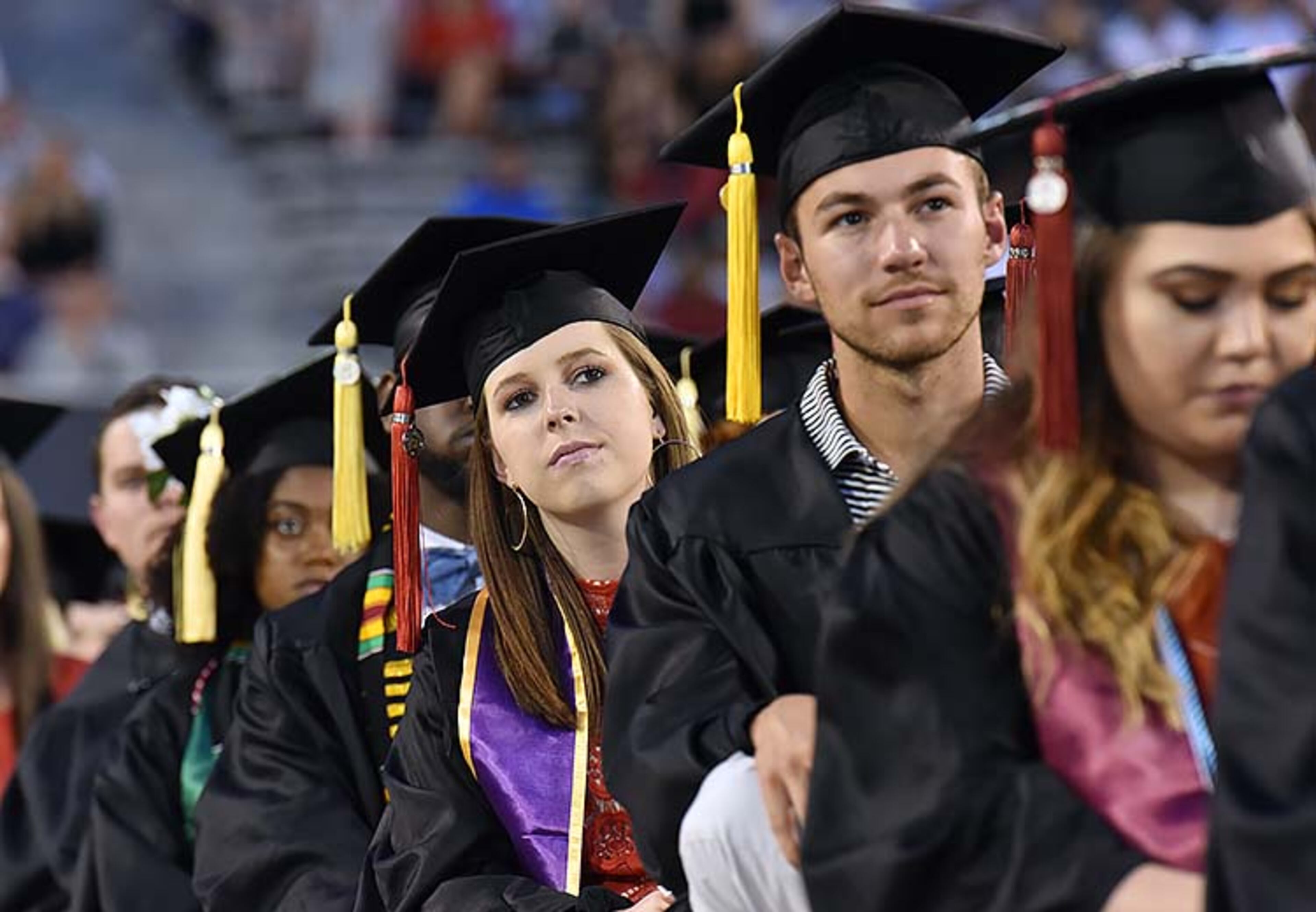 May 10, 2019 Athens - Students listen to commencement speaker Deborah Ann Roberts, news correspondent, during UGA's 2019 spring undergraduate commencement ceremony at Sanford Stadium in Athens on Friday, May 10, 2019. HYOSUB SHIN / HSHIN@AJC.COM