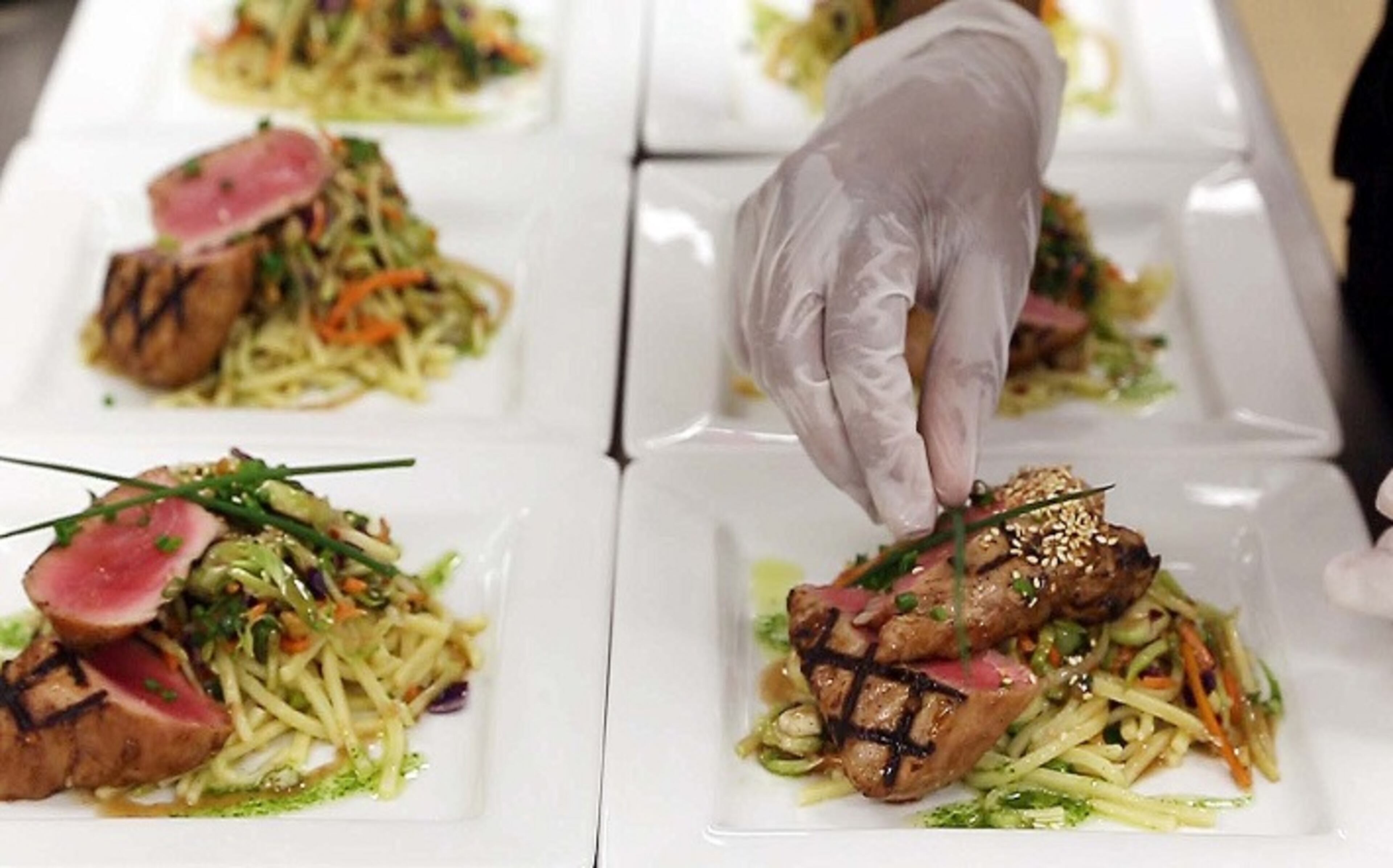 Chef Edgardo Llopiz Rivera puts the finishing touches on some dishes he prepared in the kitchen at The Bamboo Cafe in West Kendall Baptist Hospital on May 2, 2016 in Miami. (Jose A. Iglesias/Miami Herald/TNS)