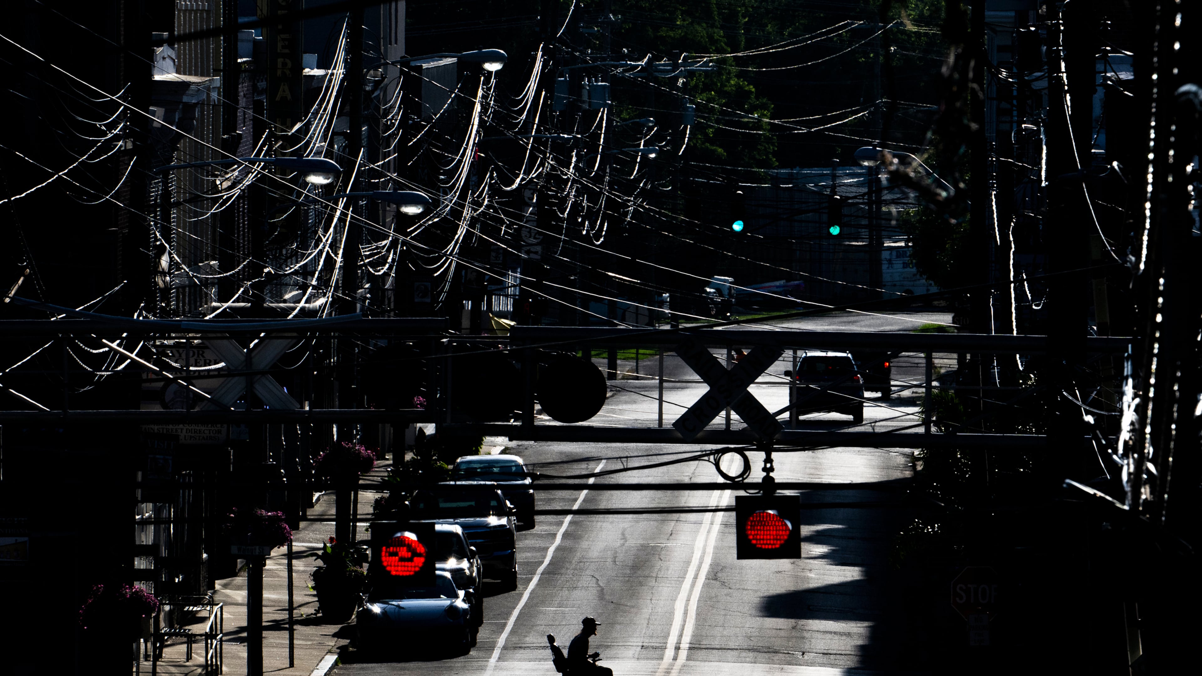 FILE - A man in an electric wheelchair crosses Pike Street in downtown Cynthiana, Ky., on June 23, 2025. (AP Photo/Michael Swensen, File)