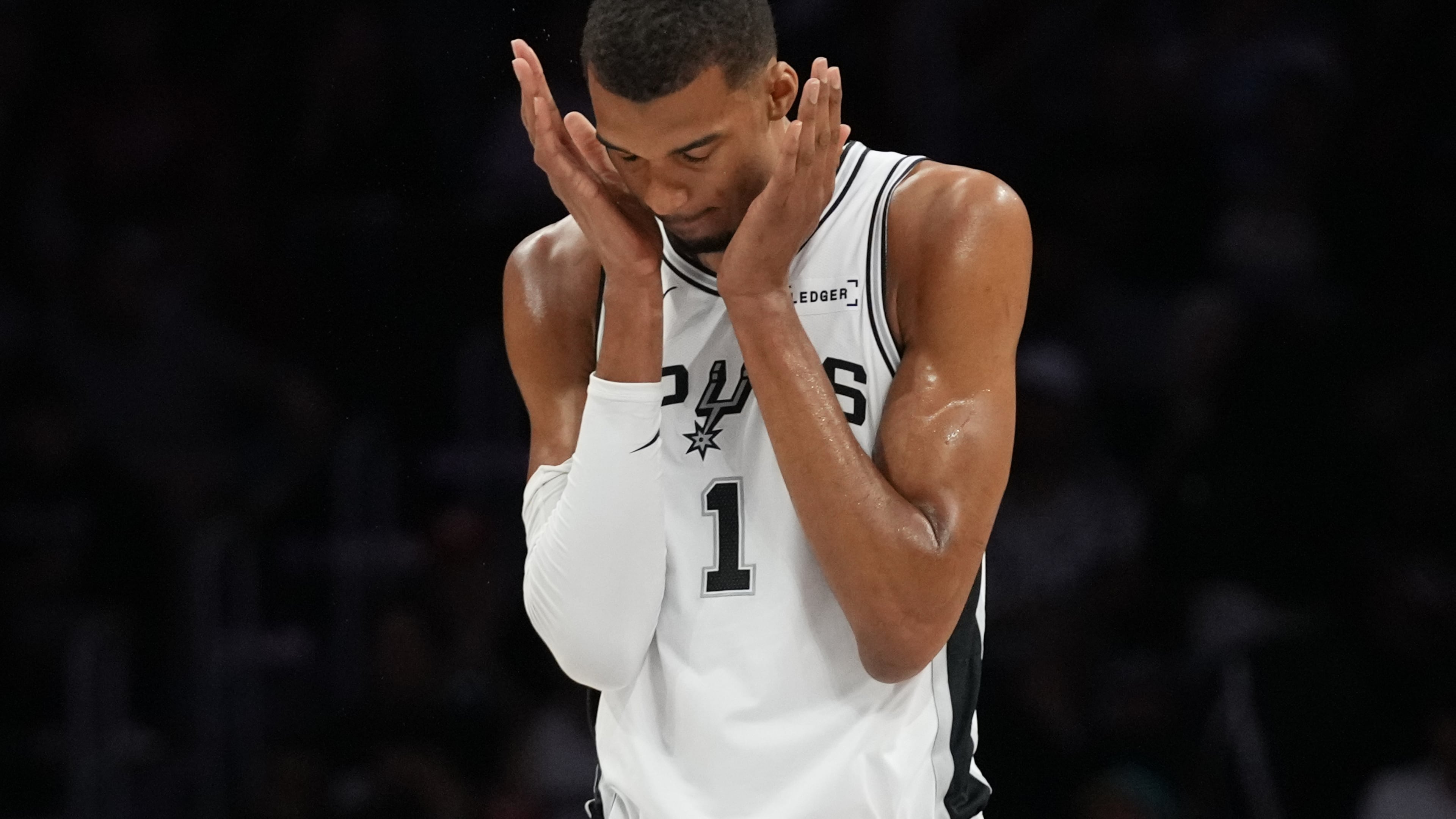 San Antonio Spurs forward Victor Wembanyama (1) walks on the court during the first half of an NBA basketball game against the Miami Heat, Monday, March 23, 2026, in Miami. (AP Photo/Lynne Sladky)