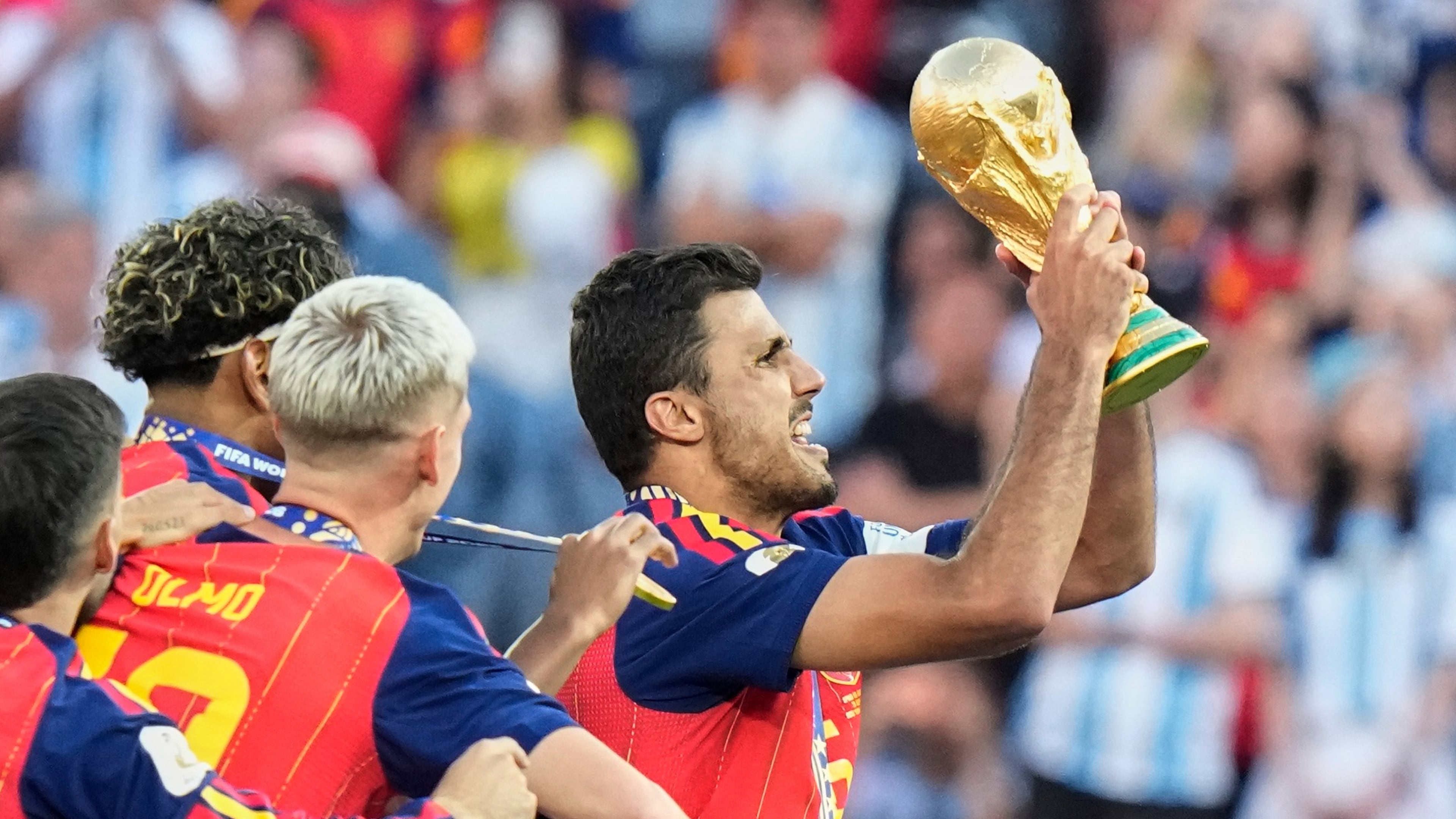 Spain's Rodri (16) lifts the winners' trophy after their win in the World Cup final soccer match against Argentina in East Rutherford, N.J., near New York, Sunday, July 19, 2026. (AP Photo/Frank Franklin II)