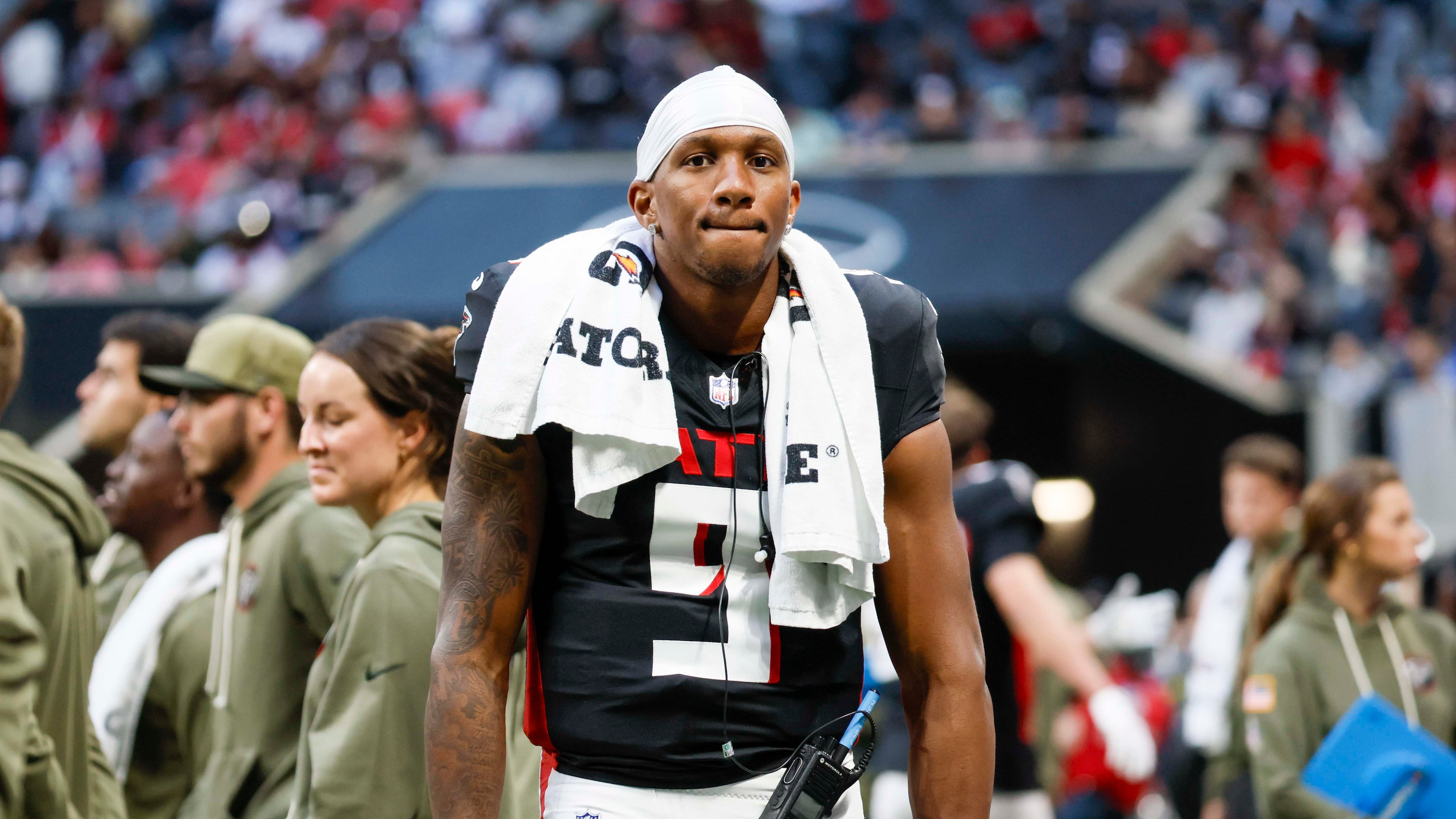 Falcons quarterback Michael Penix Jr. stands on the sidelines after leaving the field with an apparent injury during the second half against the Carolina Panthers at Mercedes-Benz Stadium on Sunday, Nov. 16, 2025, in Atlanta. (Miguel Martinez/AJC)