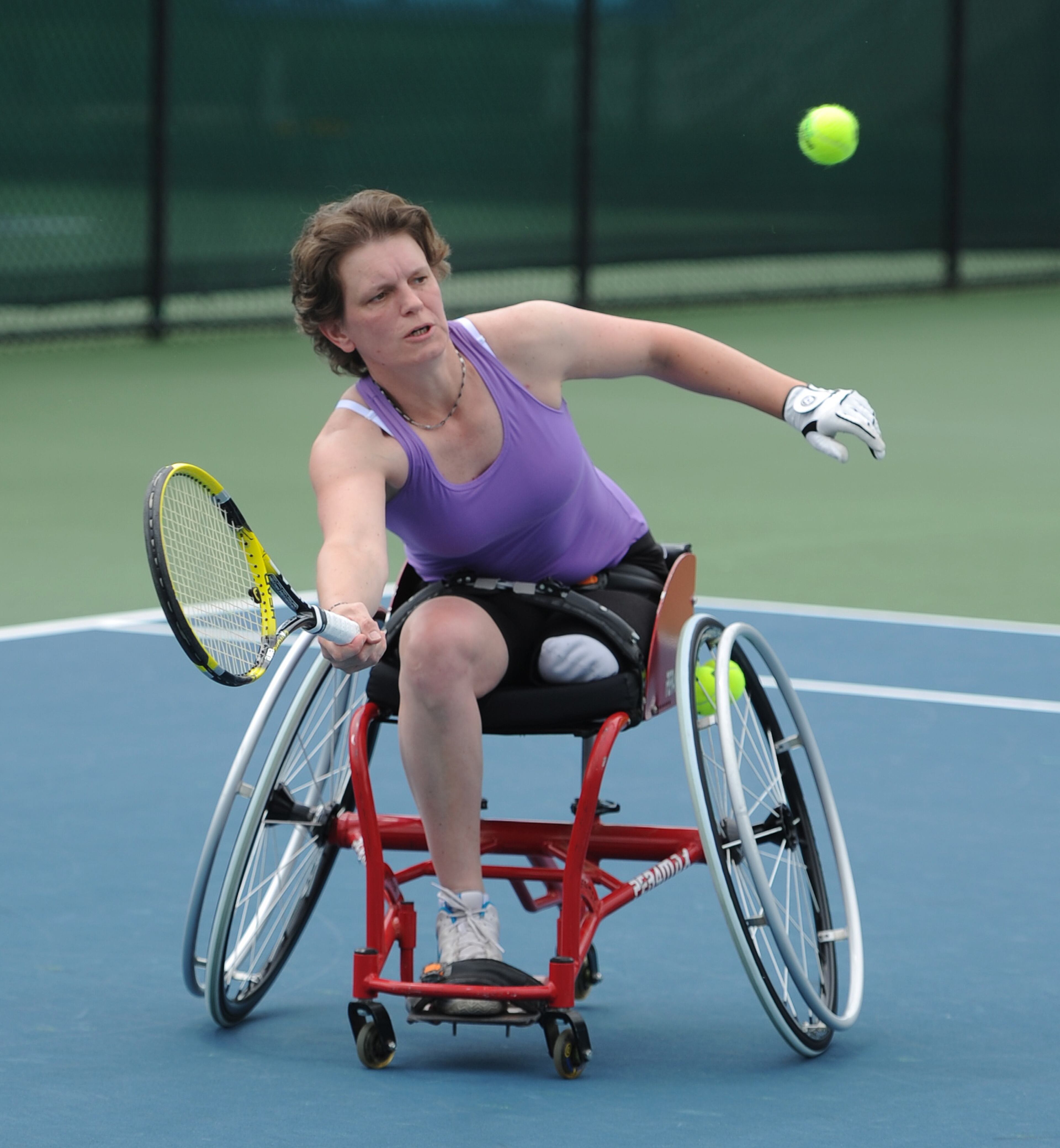 Charlotte Famin, France, reaches for the ball during her match with Katharina Kruger , Germany, during the Atlanta Open Wheelchair Tennis Championships at the Dunwoody Country Club on Wednesday, May 1, 2013. JOHNNY CRAWFORD / JCRAWFORD@AJC.COM