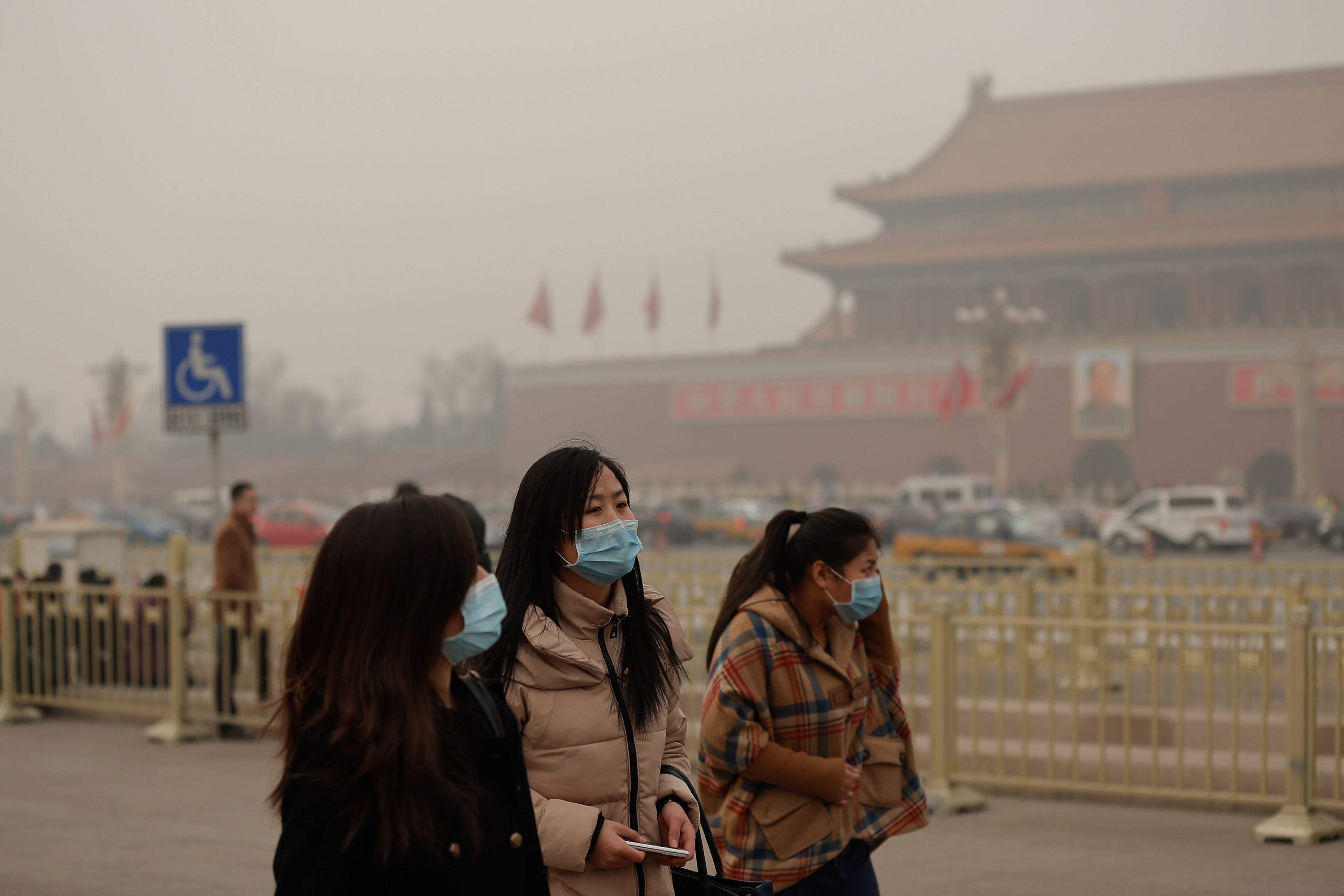 Chinese tourist wearing the masks at the Tiananmen Square during severe pollution on February 25, 2014 in Beijing, China. The air pollution has caused an increase in the number of people seeking hospital treatment for respiratory problems and the public are asked to avoid outdoor activities.