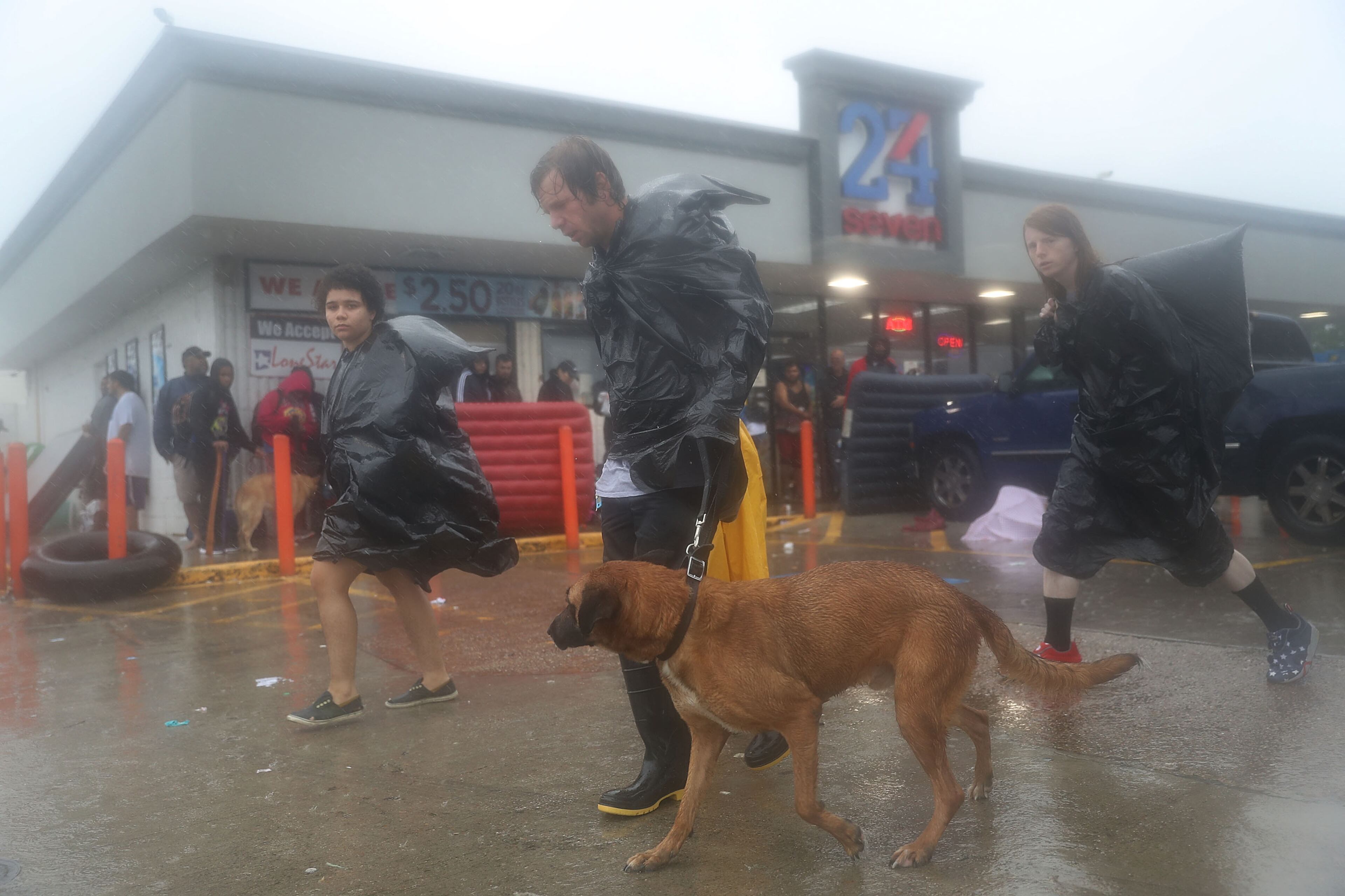 HOUSTON, TX - AUGUST 28: People flee their homes after the area was inundated with flooding from Hurricane Harvey on August 28, 2017 in Houston, Texas. Harvey, which made landfall north of Corpus Christi late Friday evening, is expected to dump upwards to 40 inches of rain in Texas over the next couple of days. (Photo by Joe Raedle/Getty Images)