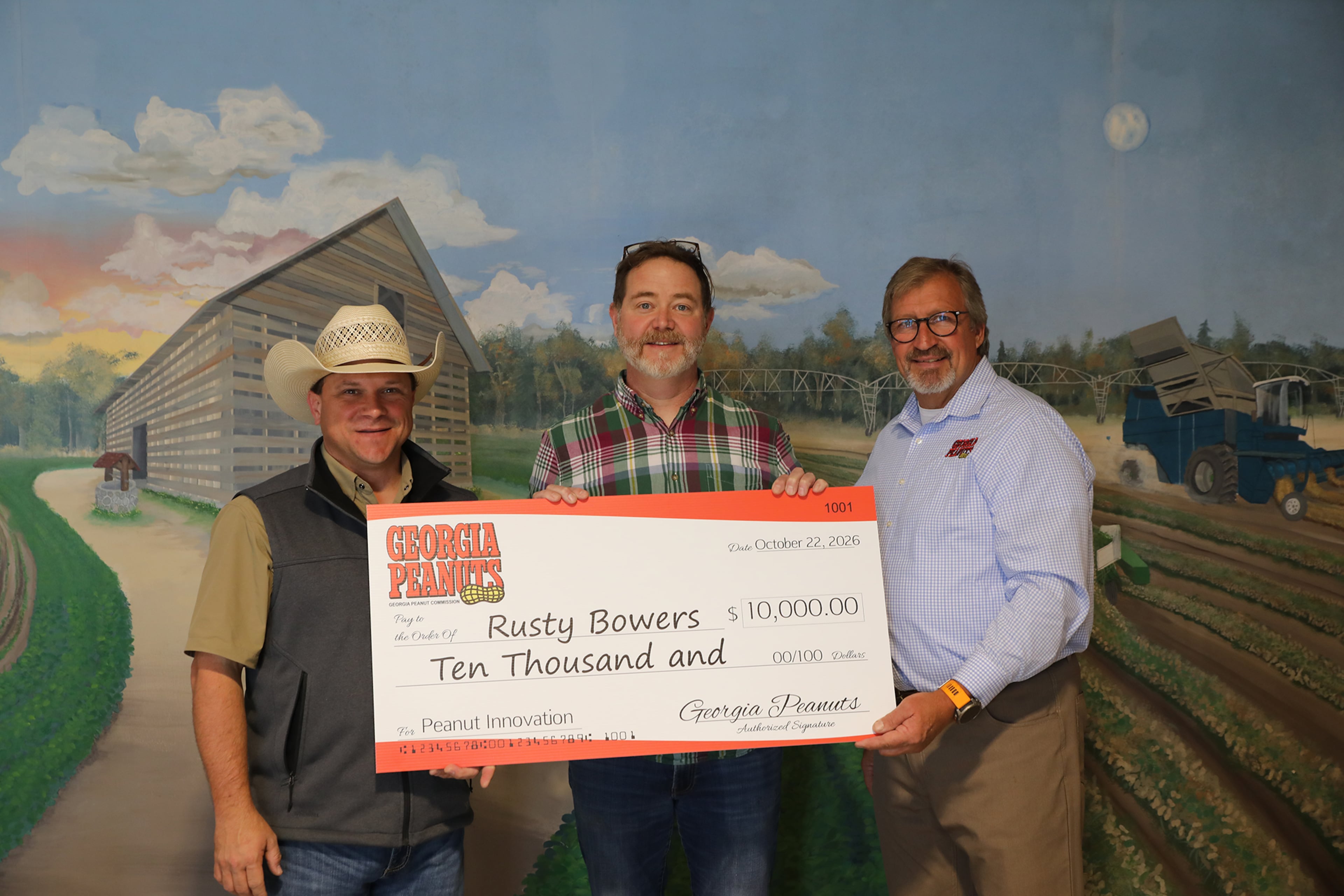 Pine Street Market owner Rusty Bowers (center) accepts a prize check from Georgia Commissioner of Agriculture Tyler J. Harper (left) and Georgia Peanut Commission Chairman Donald Chase. (Courtesy of Georgia Peanut Commission)