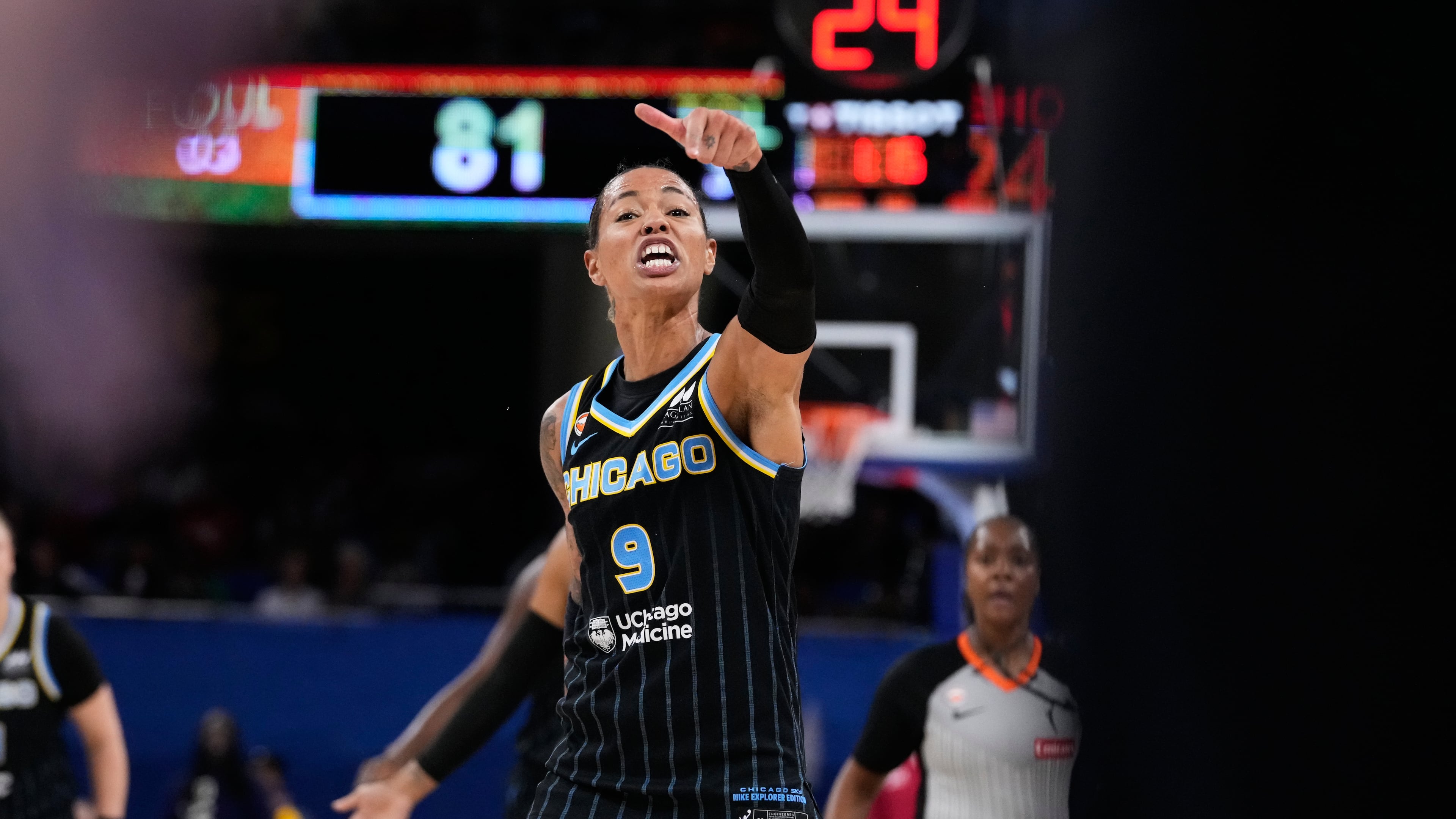 Chicago Sky guard Natasha Cloud argues with former NBA center Enes Kanter Freedom, right, during the second half of a WNBA basketball game against the Indiana Fever, Sunday, Aug. 23, 2026, in Chicago. (AP Photo/Nam Y. Huh)