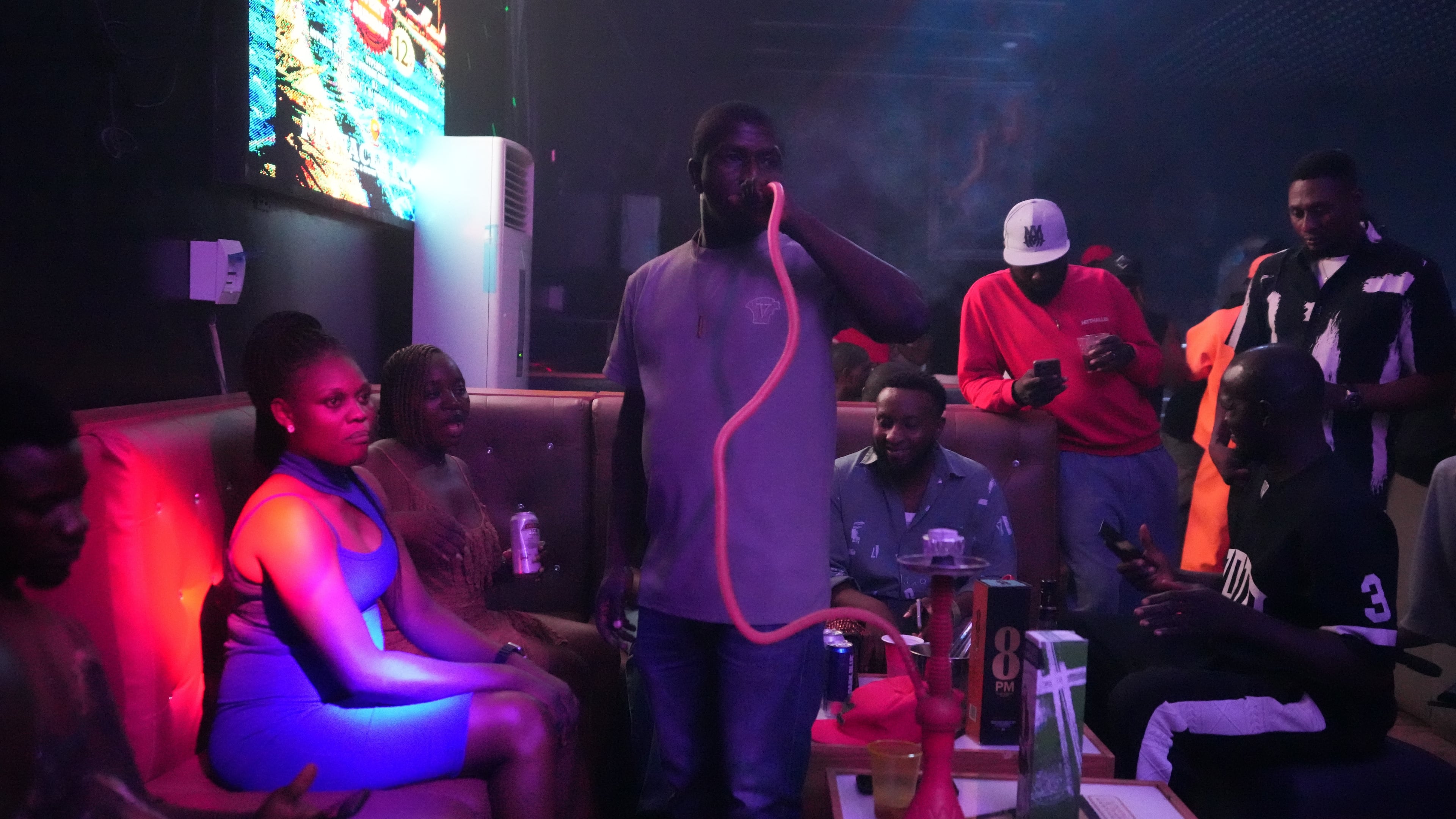 Vincent Tabat smokes a waterpipe inside a nightclub in Sokoto, Nigeria, July 18, 2026. (AP Photo/Sunday Alamba)